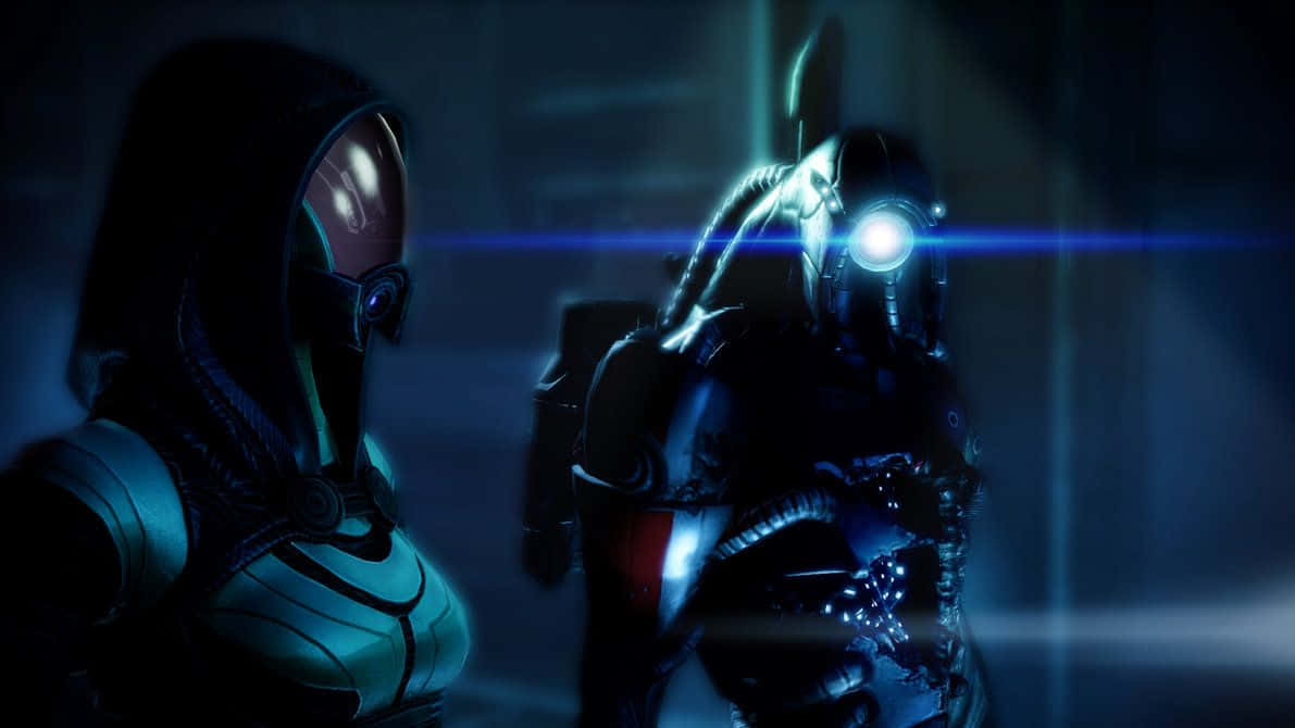 Mass Effect Legion 桌布 壁紙 — 兩個身穿暗色未來裝備的裝甲人物站在昏暗的藍色走廊中，眼睛發光並帶有鏡頭光暈。