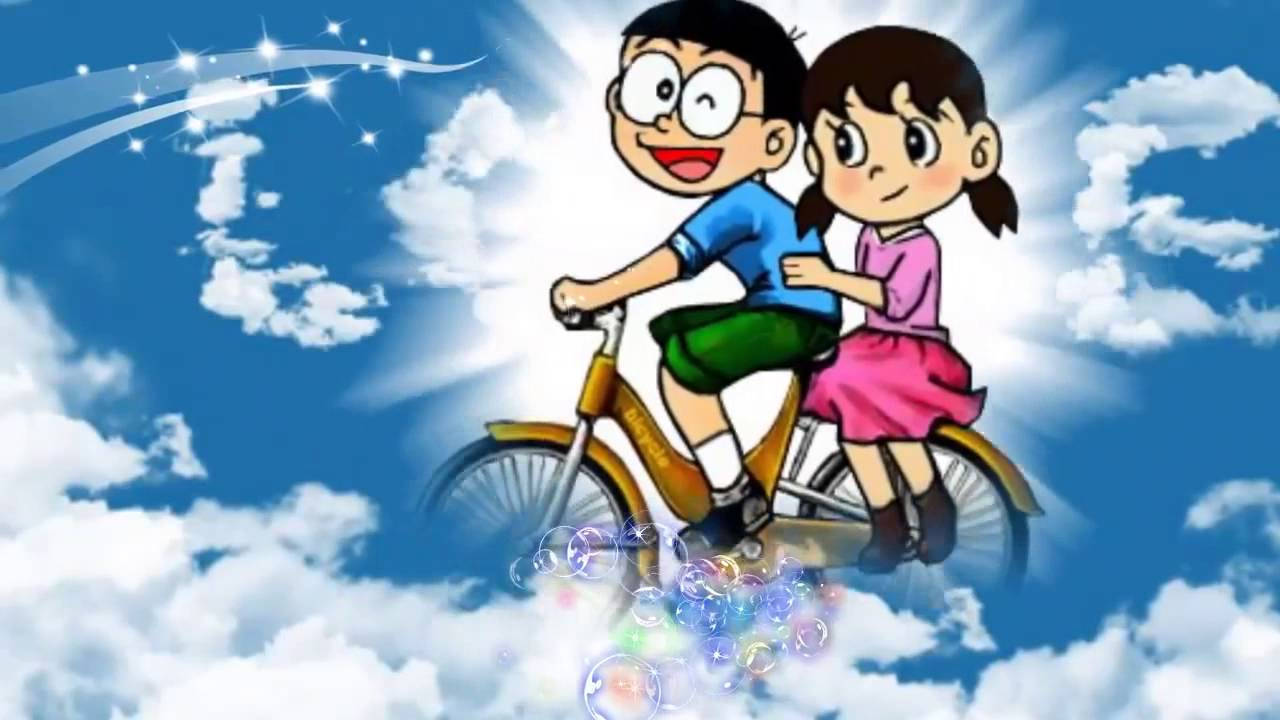 Doraemon 桌布 壁紙 — 兩個開心的動畫小孩騎腳踏車穿過 fluffy 雲朵，下面有閃爍的軌跡和彩色泡泡。