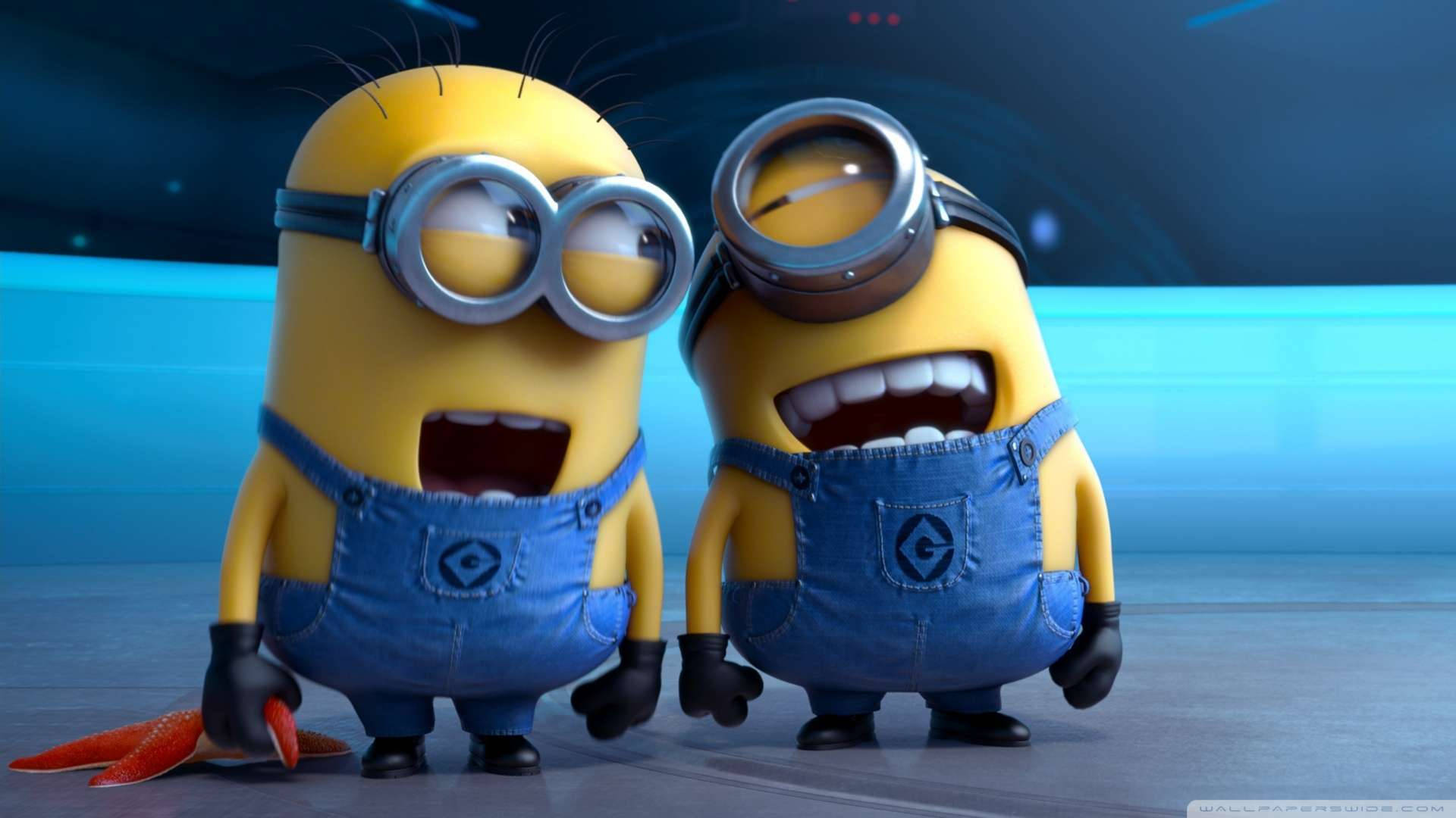 電影動圖 桌布 壁紙 — 兩個黃色Minions穿著藍色工裝褲和護目鏡，在未來風格的藍色實驗室中咧嘴大笑。