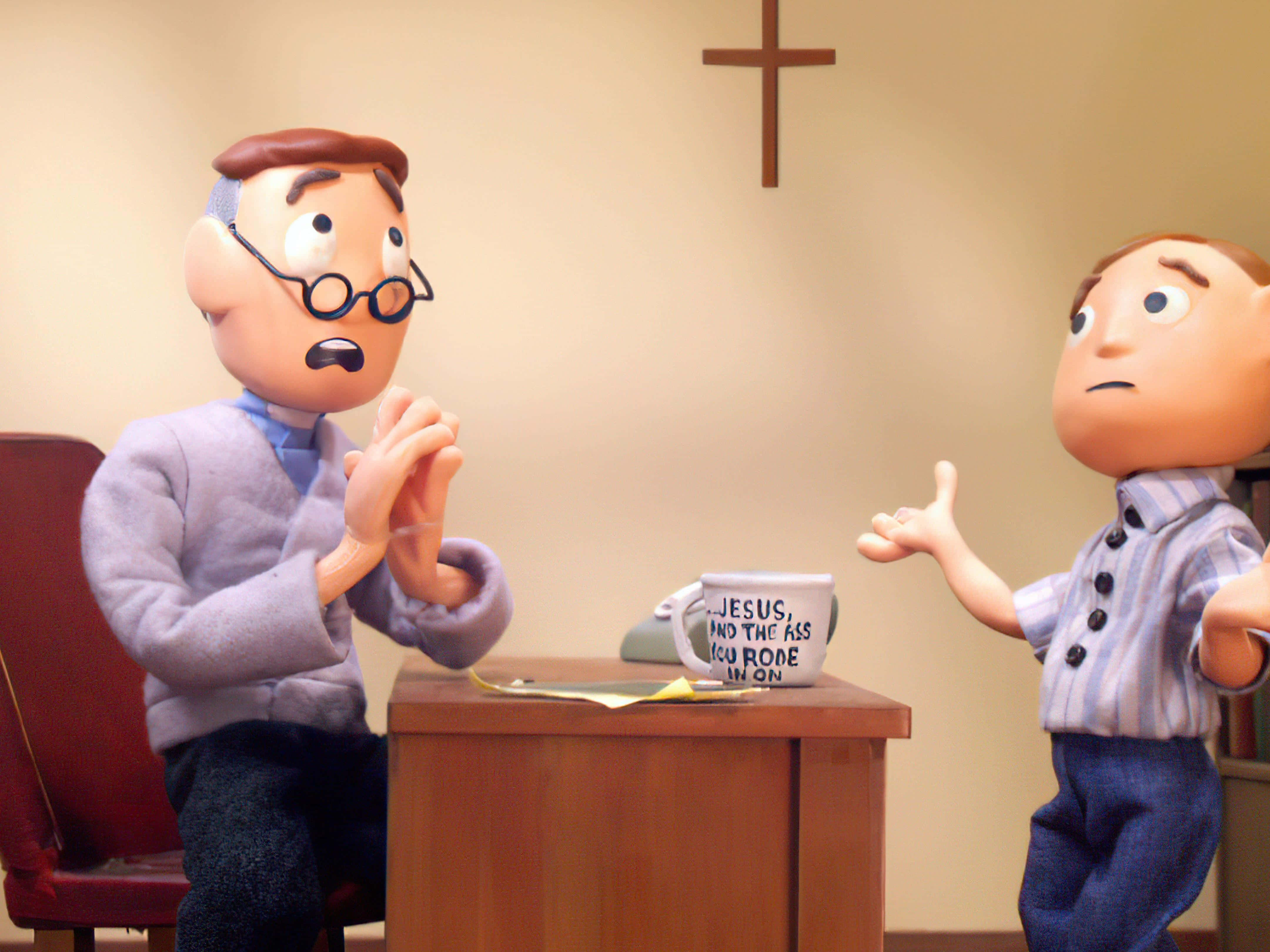 Psychology 桌布 壁紙 — 兩個黏土動畫人物在辦公桌前爭論，桌上有一個寫著「Jesus and the ass you rode in on」的馬克杯，下方有一個十字架。