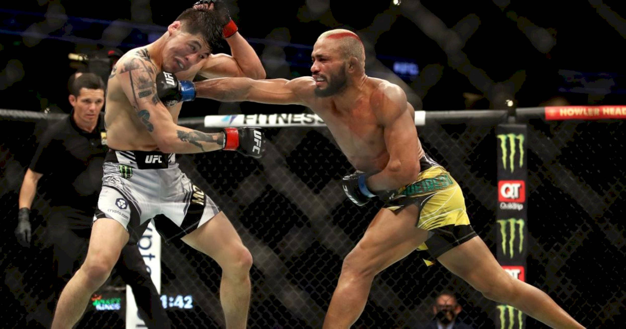 MMA 桌布 壁紙 — 兩名MMA拳手在明亮的場館燈光下進行激烈的鐵籠賽，裁判在旁緊密注視。
