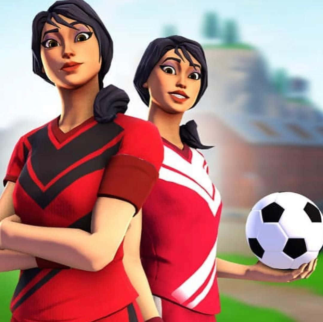 Sweaty Soccer Skin 桌布 壁紙 — 兩名動畫女性足球員身穿紅色制服自信地站立，其中一人持球，背景為模糊的戶外球場。