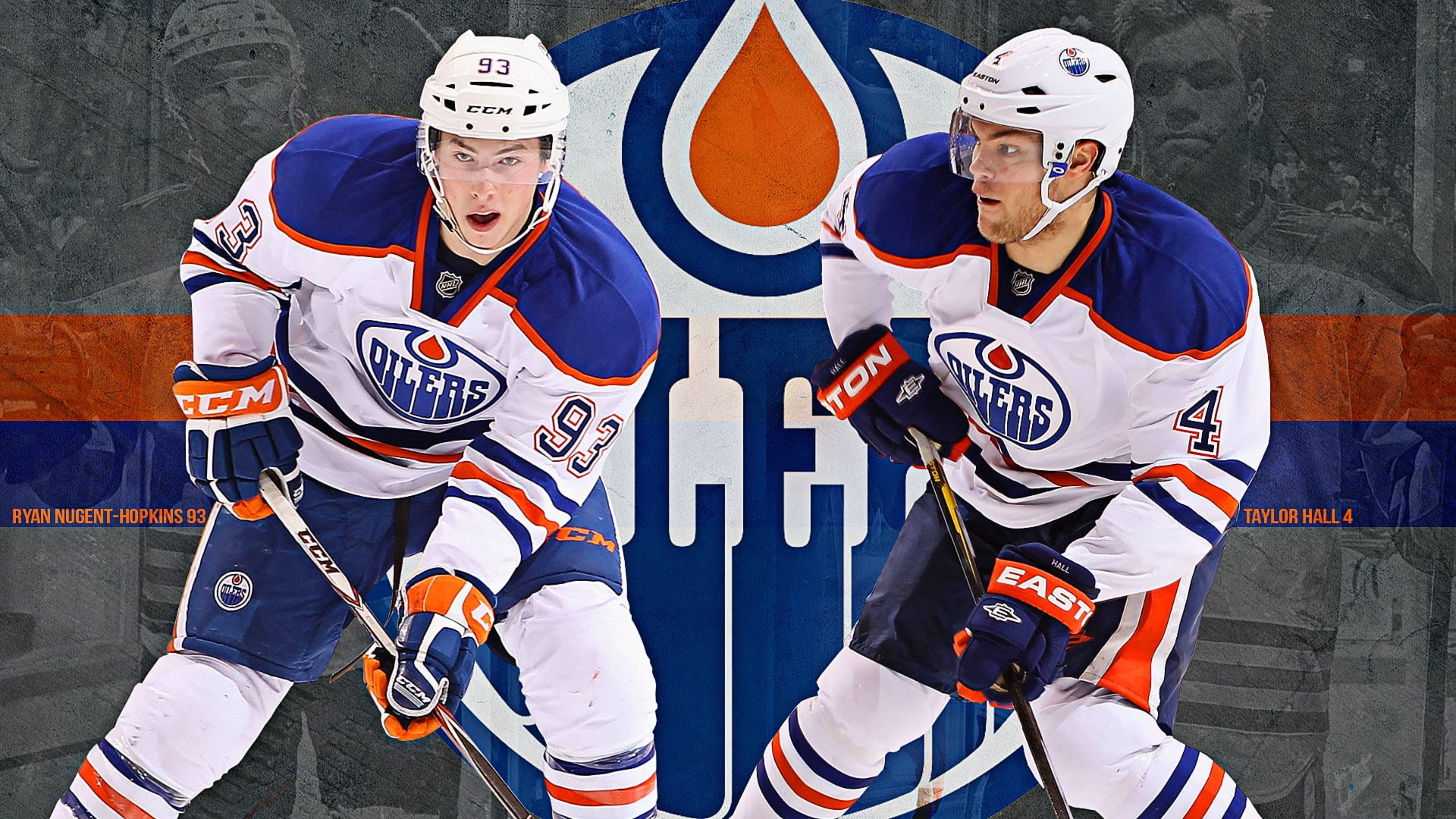 Oilers 桌布 壁紙 — 兩名埃德蒙頓油人冰球球員以動作姿勢呈現，背景為球隊標誌。