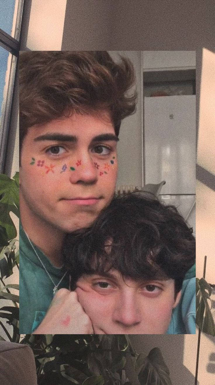 gay love 桌布 壁紙 — 兩名年輕男子臉上塗有彩色顏料，在室內靠近有植物的窗戶近距離擺姿勢。