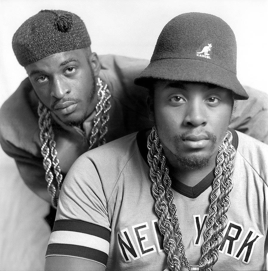 Rappers 桌布 壁紙 — 兩名戴著漁夫帽和粗鏈條的男子在鮮明的黑白工作室肖像中凝視著相機。