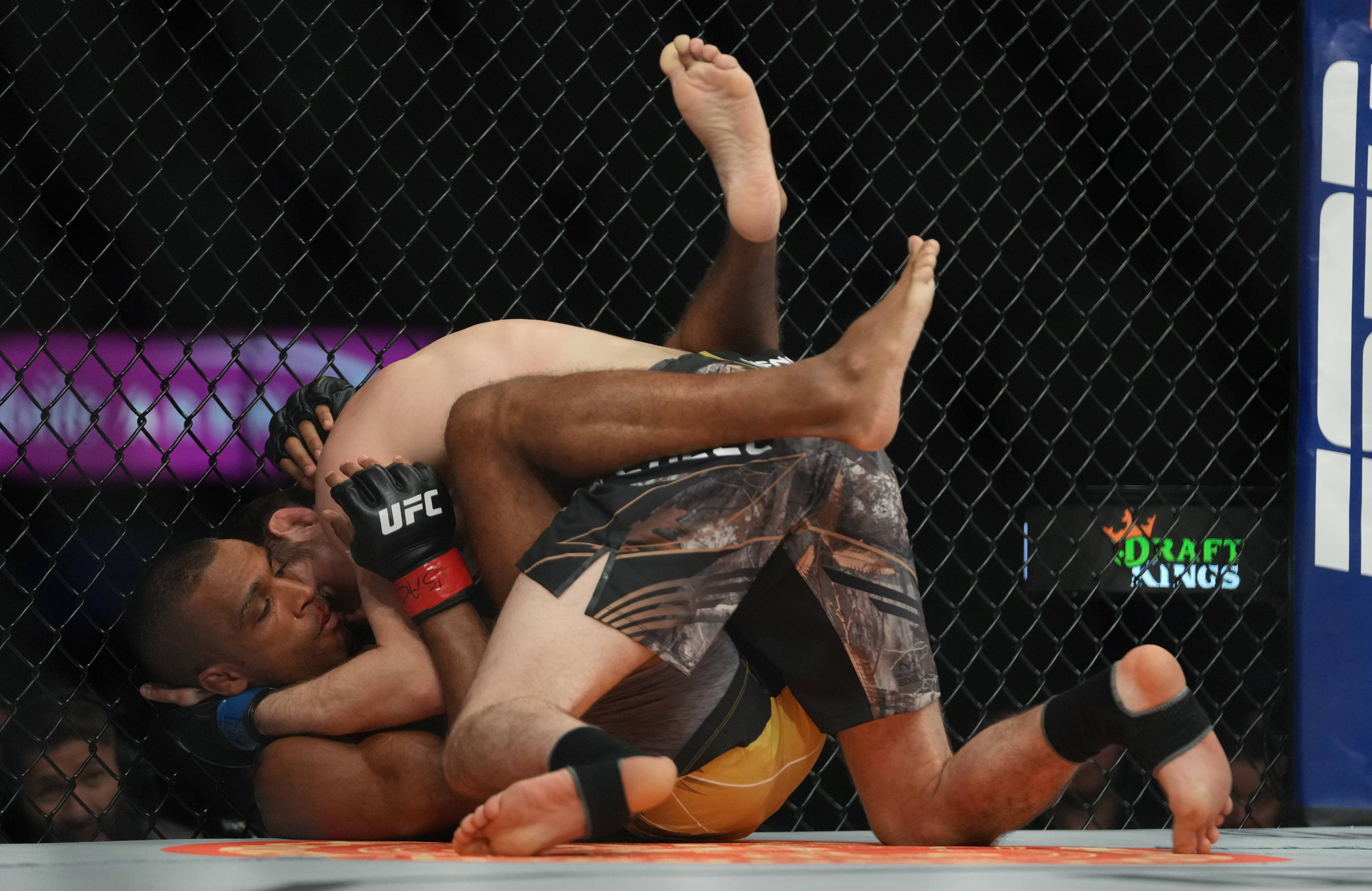 MMA 桌布 壁紙 — 兩名拳手在UFC八角籠內激烈纏鬥，其中一人施展鎖喉技。