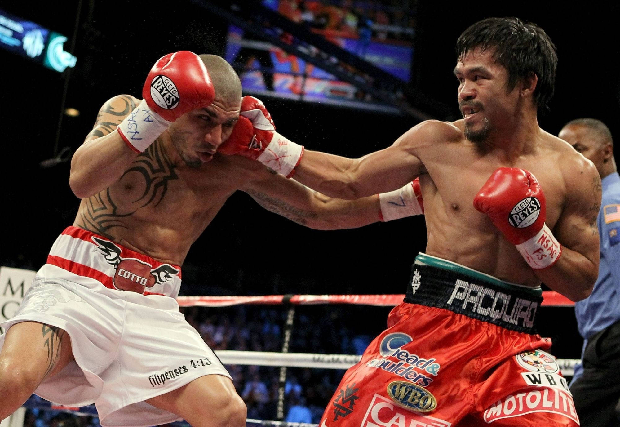 Boxing 桌布 壁紙 — 兩名拳擊手在激烈的擂台上交鋒，汗水飛濺，在明亮的場館燈光下表情猙獰。