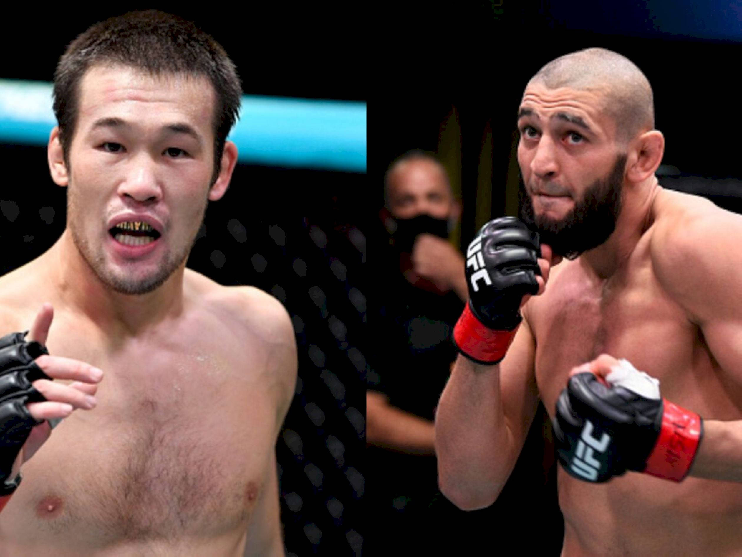 UFC 桌布 壁紙 — 兩名激烈的UFC拳手在八角籠中對峙，神情專注，戴著手套的拳頭準備好戰鬥。