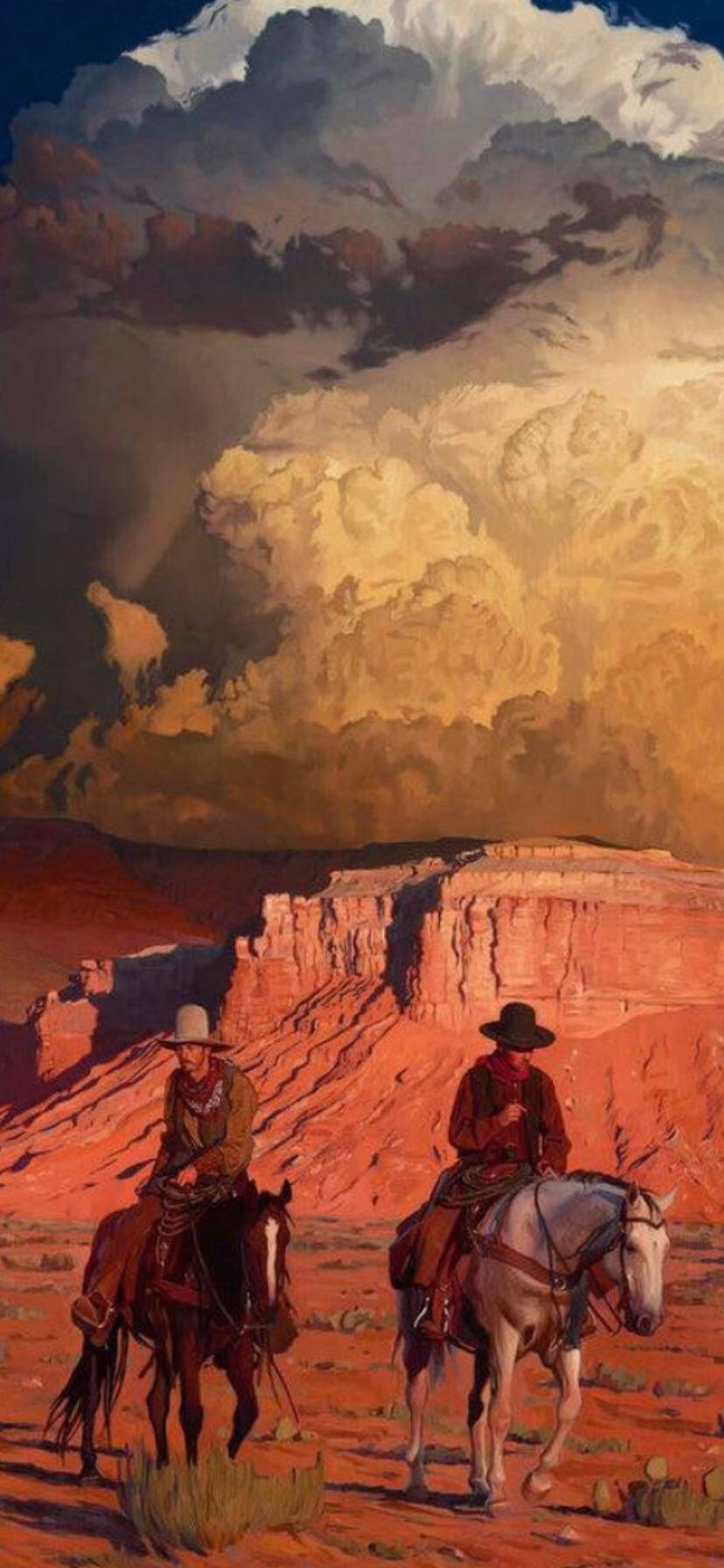 Cowboy 桌布 壁紙 — 兩名牛仔騎馬穿過廣闊的紅色沙漠峽谷，天空戲劇性地呈現金色和暴風雨景象。