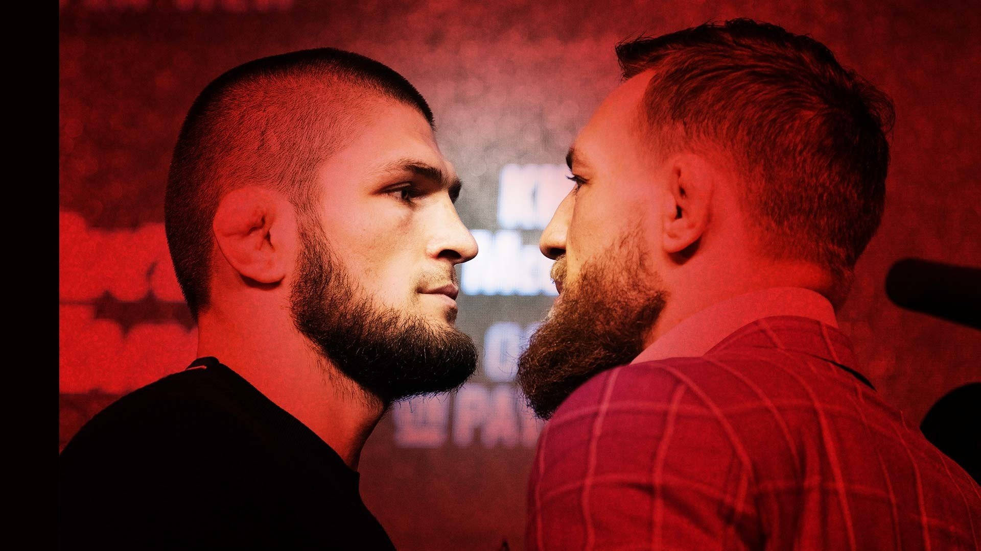 Mcgregor 桌布 壁紙 — 兩名留鬍的戰士在強烈的紅光下對峙，表情嚴肅。