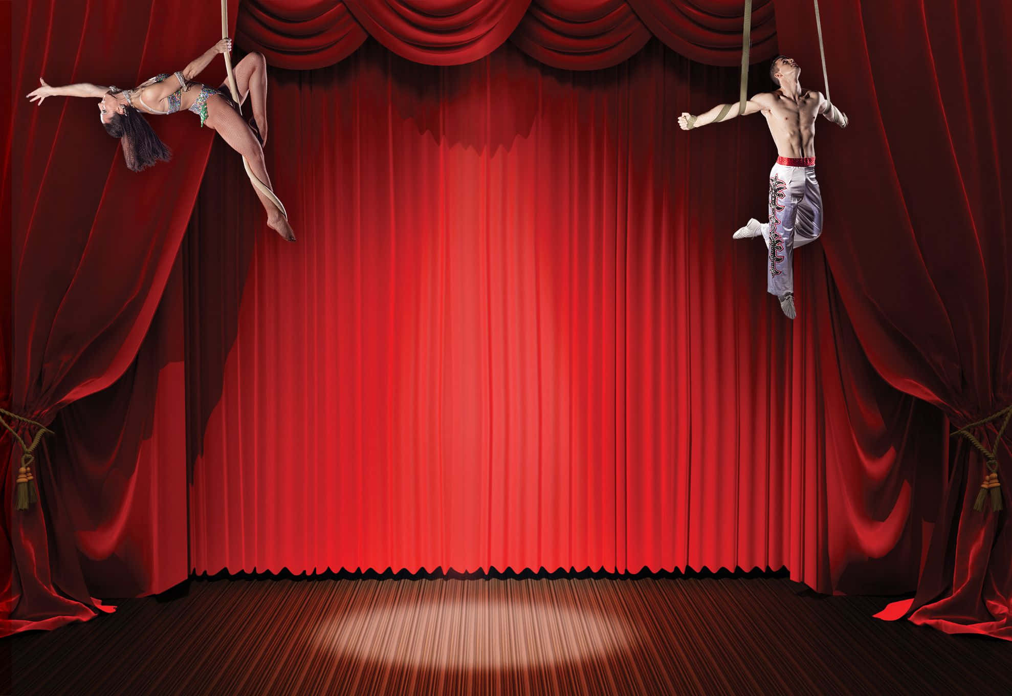 Circus 桌布 壁紙 — 兩名空中表演者在聚光燈下，懸掛在繩索上，以宏偉的紅色劇院幕布為背景，擺出優雅的姿勢。