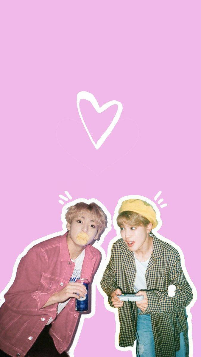 Jikook 桌布 壁紙 — 兩名穿著休閒服的年輕男子在純粉紅色背景前玩電子遊戲，他們上方有一個白色心形。