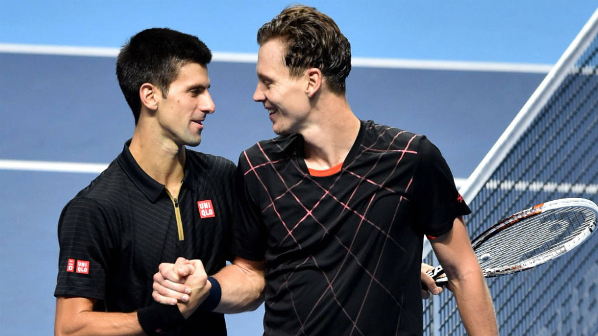 Tennis 桌布 壁紙 — 兩名網球運動員在藍色硬地球場上比賽後微笑握手。