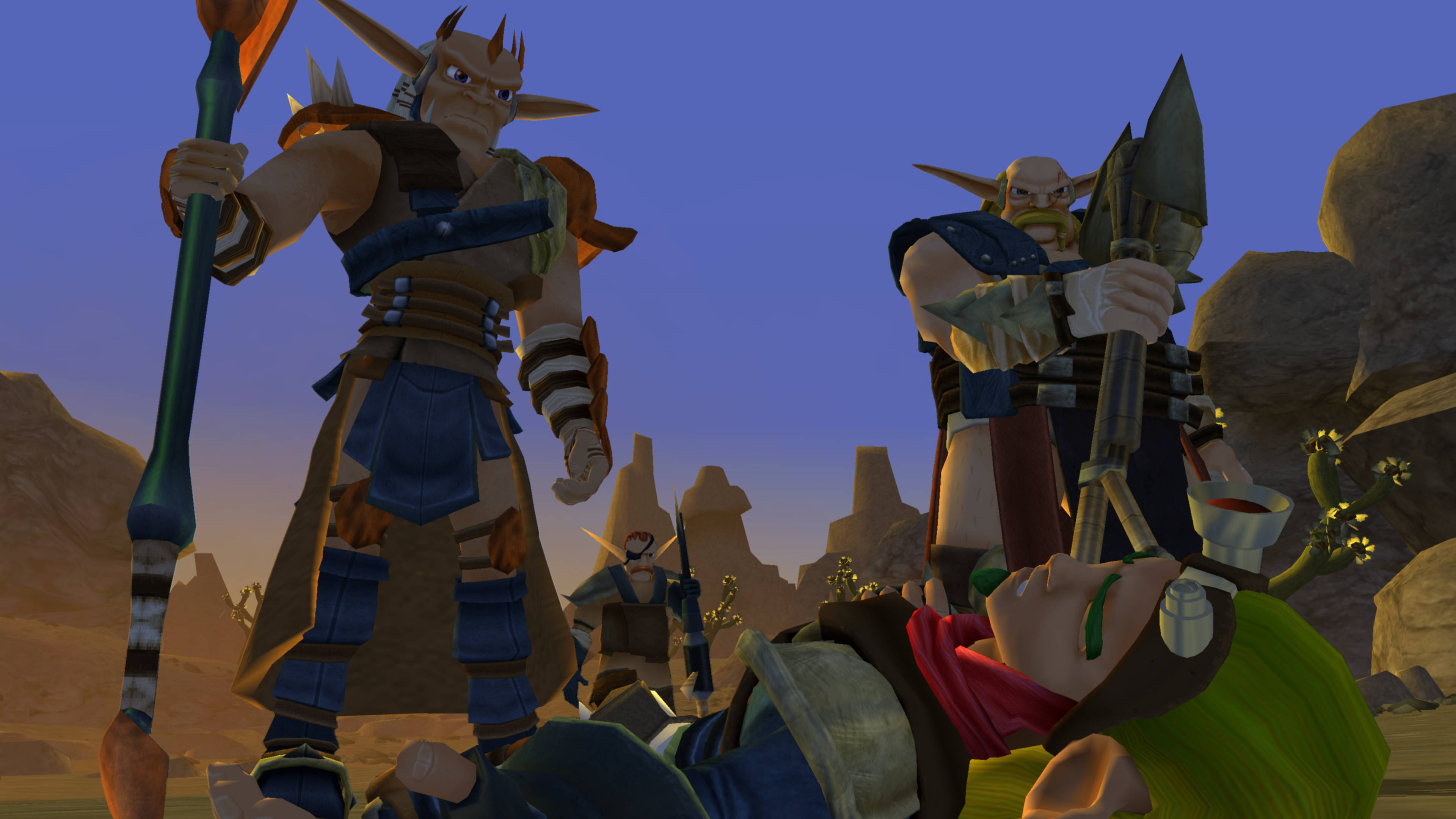 Jak 3 桌布 壁紙 — 兩名身穿盔甲的奇幻戰士在黃昏時分站在岩石沙漠峽谷中倒下的敵人之上。