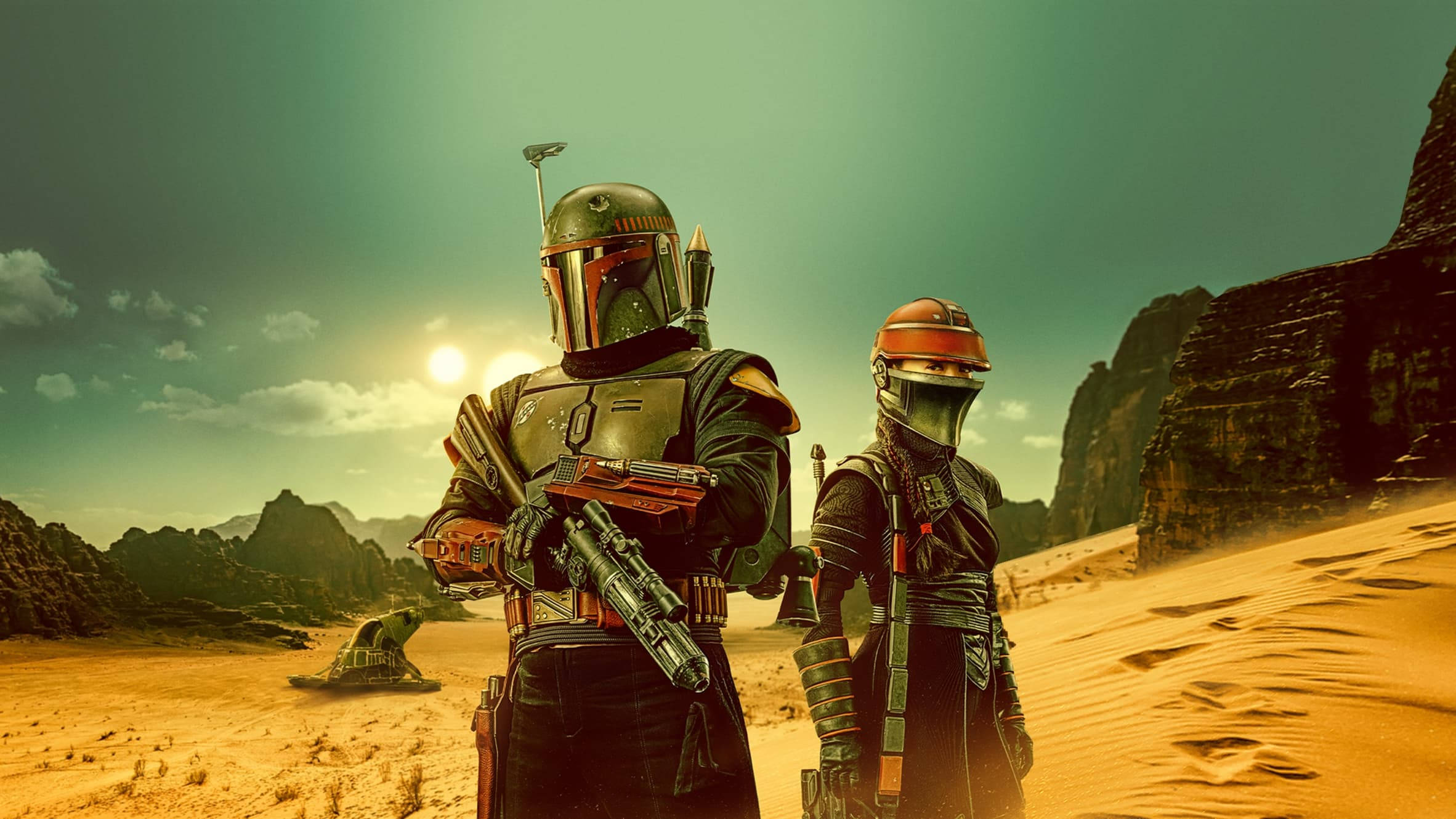 Boba 桌布 壁紙 — 兩名身穿裝甲的賞金獵人站在陽光明媚的沙漠峽谷中，周圍有岩石峭壁和遠處的飛梭摩托車。