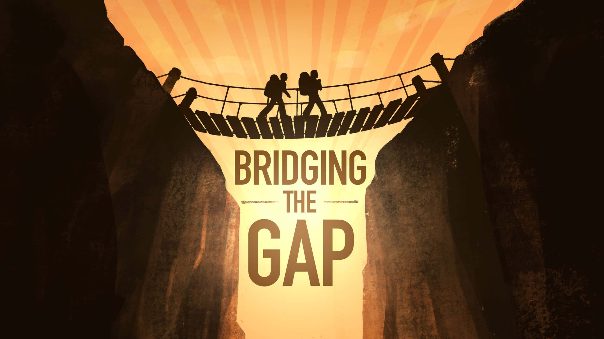Gap 桌布 壁紙 — 兩名遠足者穿過高聳懸崖之間一條危險的繩橋，金色陽光從他們身後照射出來。