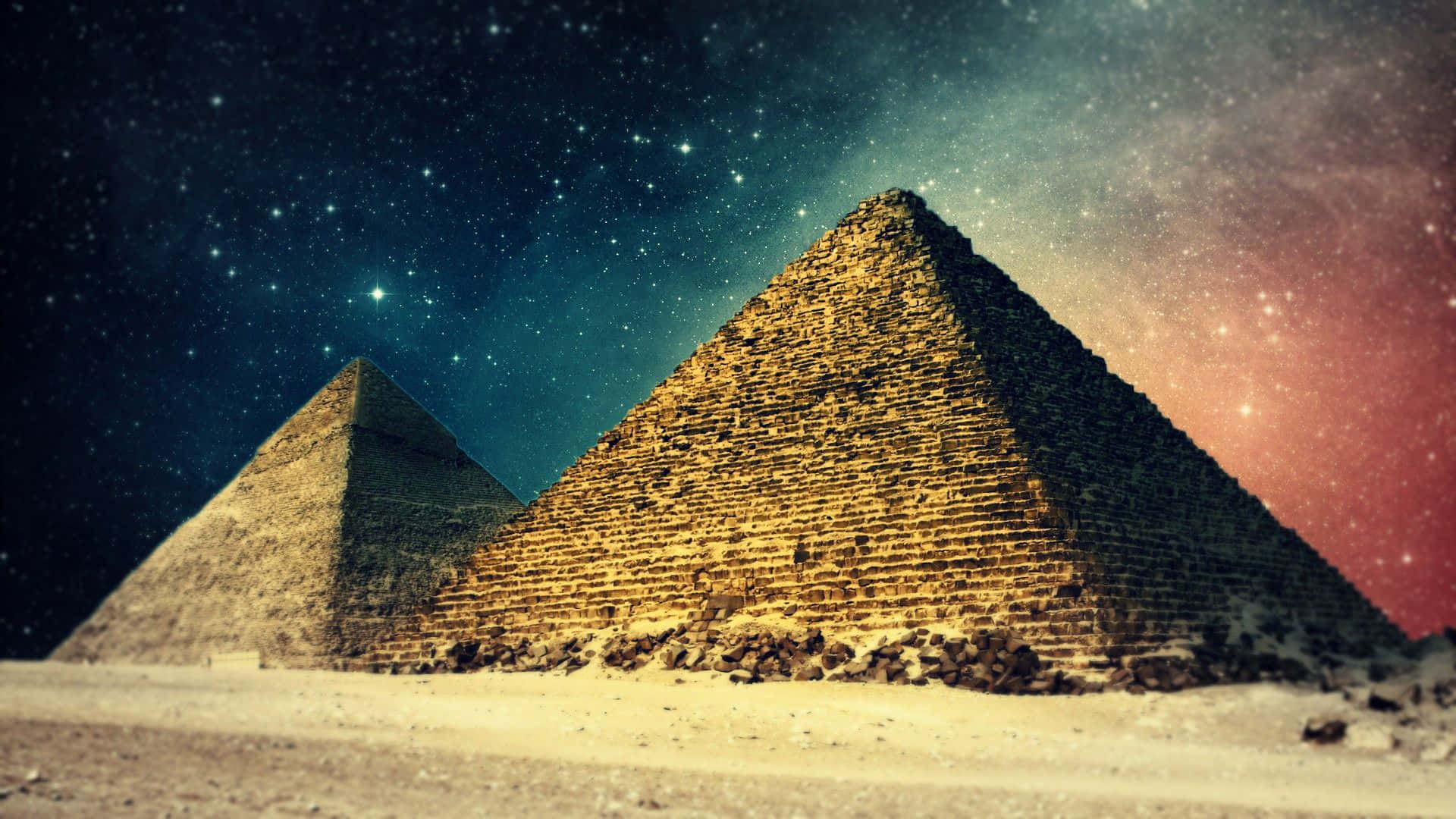 埃及 桌布 壁紙 — 兩座古老金字塔在繁星點點的夜空下巍然聳立，帶有青綠色和粉紅色的宇宙色調。