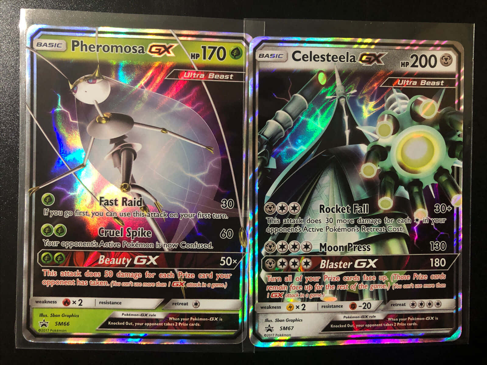 任天堂 桌布 壁紙 — 兩張閃亮的寶可夢GX卡， featuring Pheromosa GX 和 Celesteela GX，帶有全息彩虹背景。