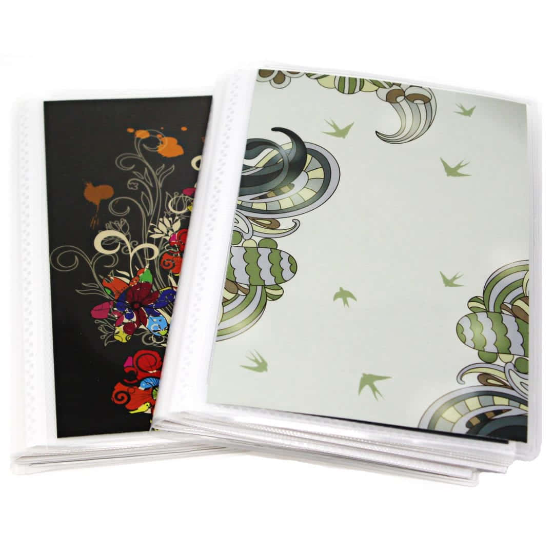album 桌布 壁紙 — 兩本裝飾性圖案相簿，帶有鮮豔色彩的花卉和鳥類圖案，分別置於深色和淺色背景上。