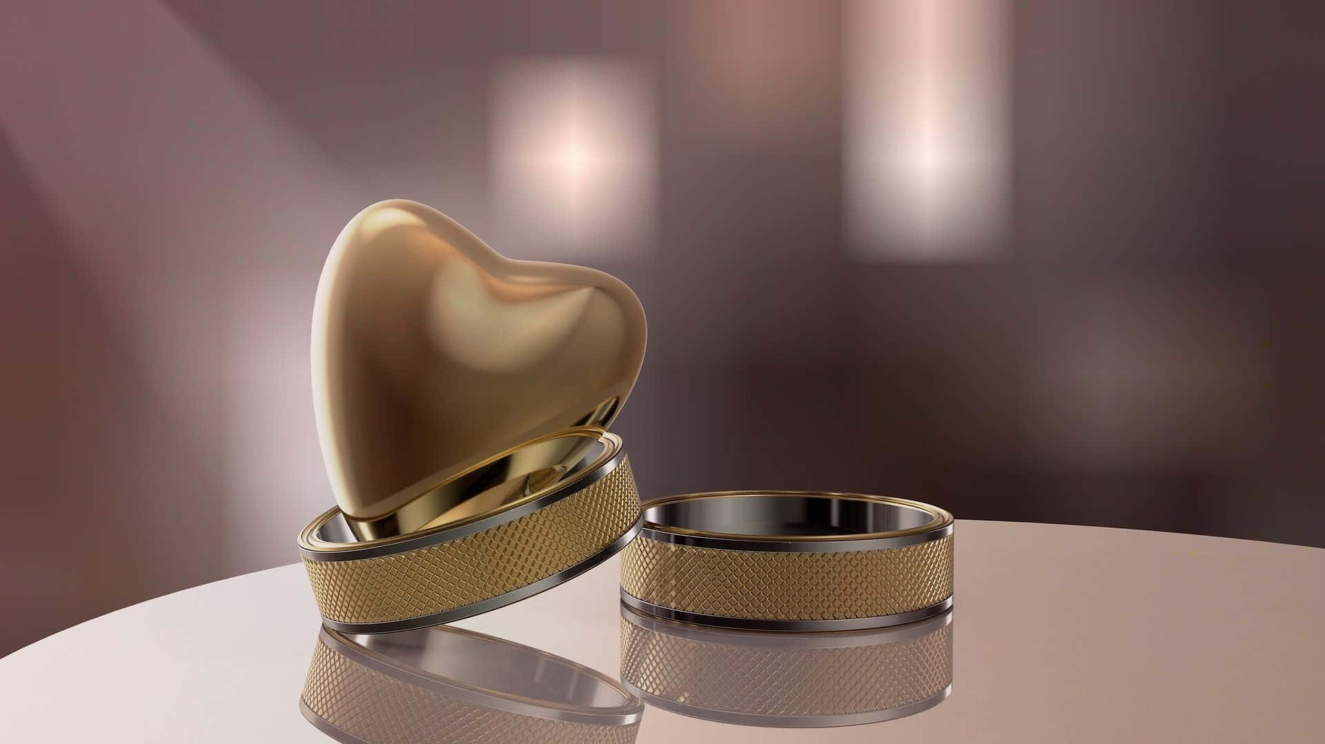 Wedding Rings 桌布 壁紙 — 兩枚金婚戒放在心形盒旁，置於反射表面上，柔和溫暖的燈光下。