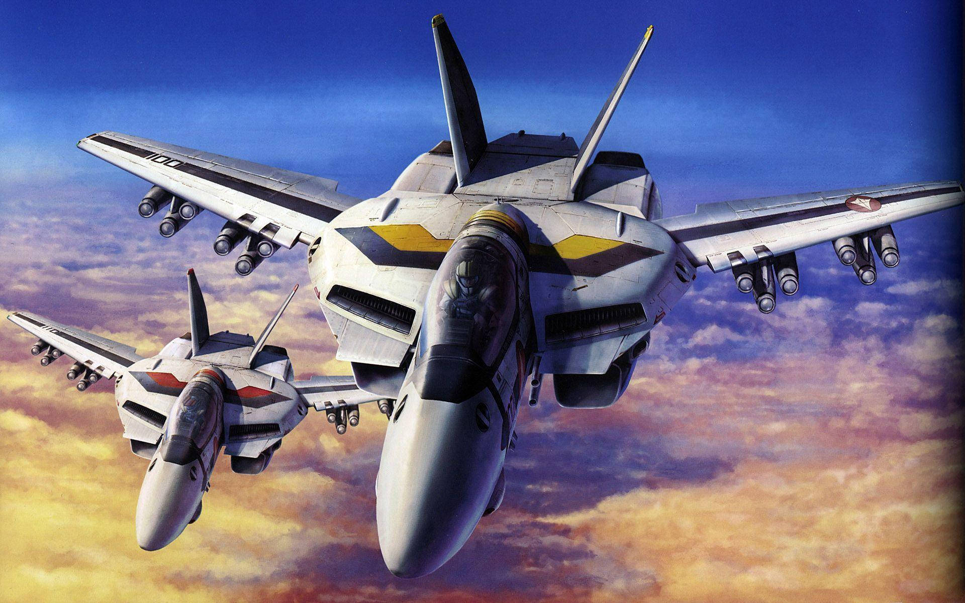 Macross 桌布 壁紙 — 兩架未來主義戰鬥機在充滿活力的日落天空和戲劇性的雲層中翱翔。