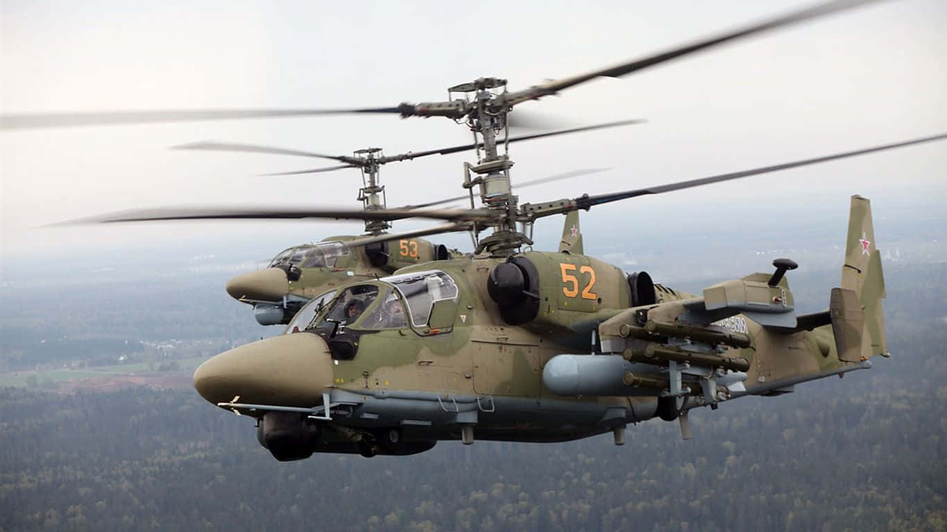 Helicopter 桌布 壁紙 — 兩架軍用攻擊直升機在森林景觀上空編隊飛行，旋翼葉片模糊。