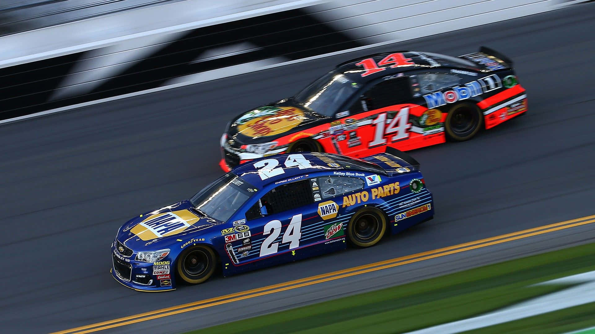 nascar 桌布 壁紙 — 兩輛NASCAR賽車在賽道上並排疾馳，動態模糊效果強調高速。