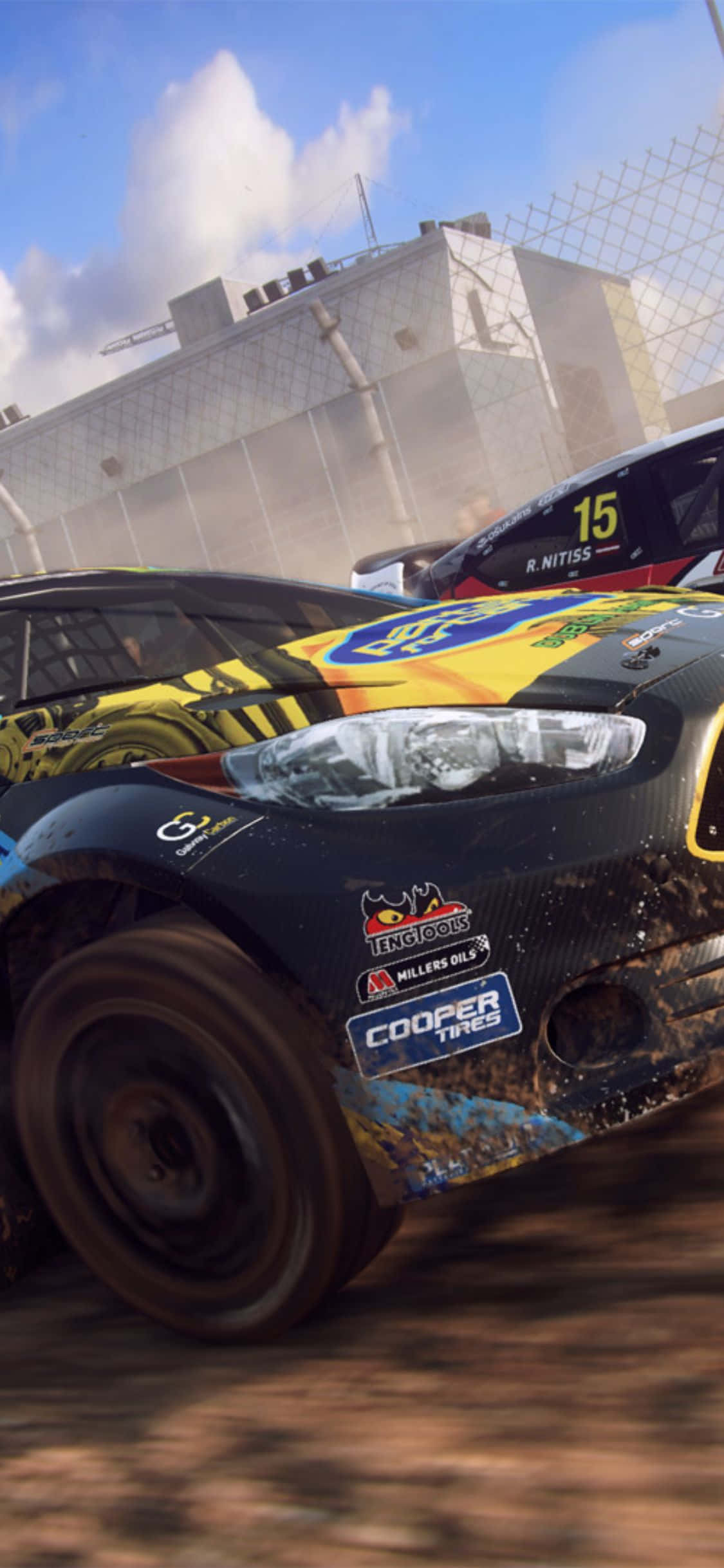 iPhone X Dirt Rally 桌布 壁紙 — 兩輛濺滿泥濘的拉力賽車在塵土飛揚的賽道上激烈競速，背景是工業建築。