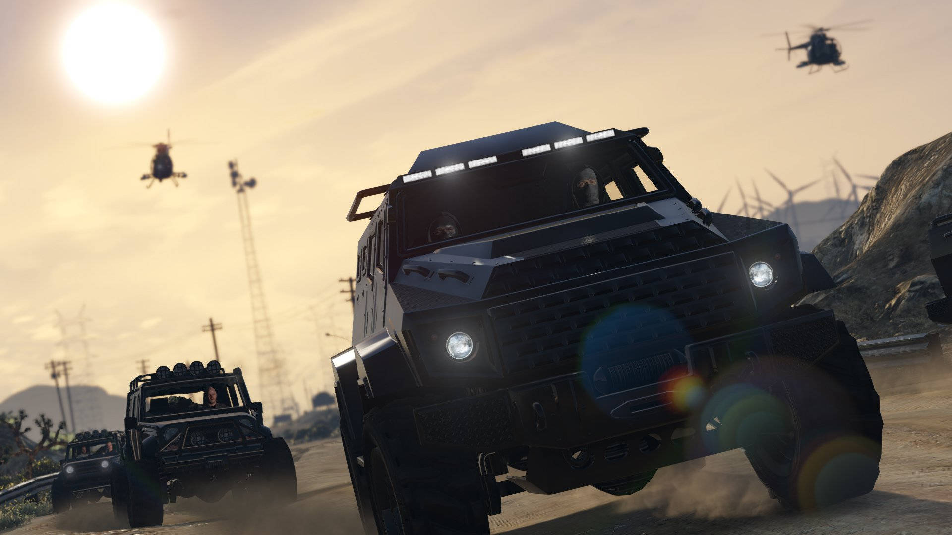 Gta 桌布 壁紙 — 兩輛裝甲軍用車輛在明亮的陽光下，頭頂有直升機飛過，穿越塵土飛揚的沙漠景觀。