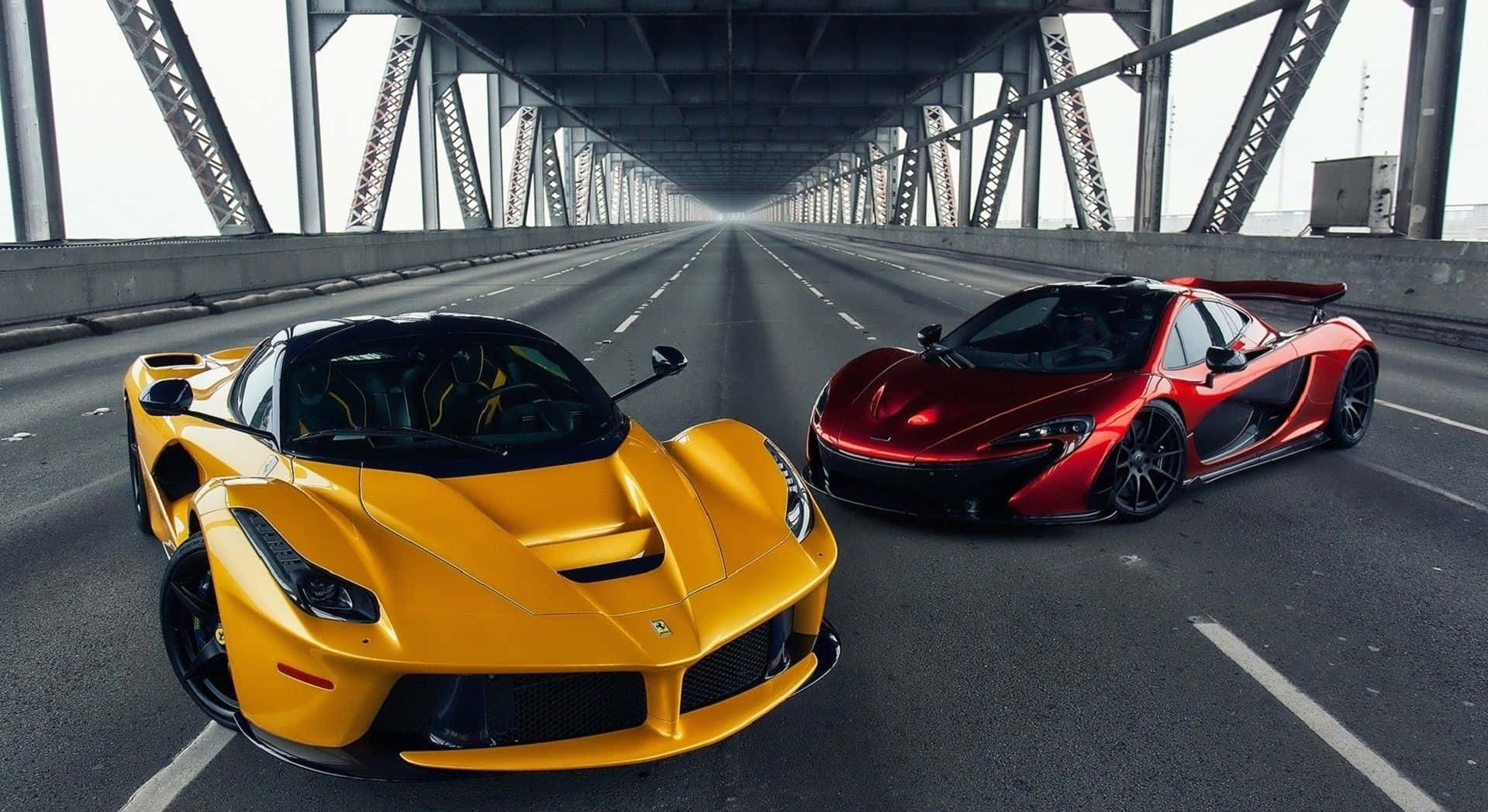Ferrari Laferrari 桌布 壁紙 — 兩輛超跑，一輛黃色法拉利和一輛紅色麥拉倫，停在鋼桁架下空蕩的橋面車道上。