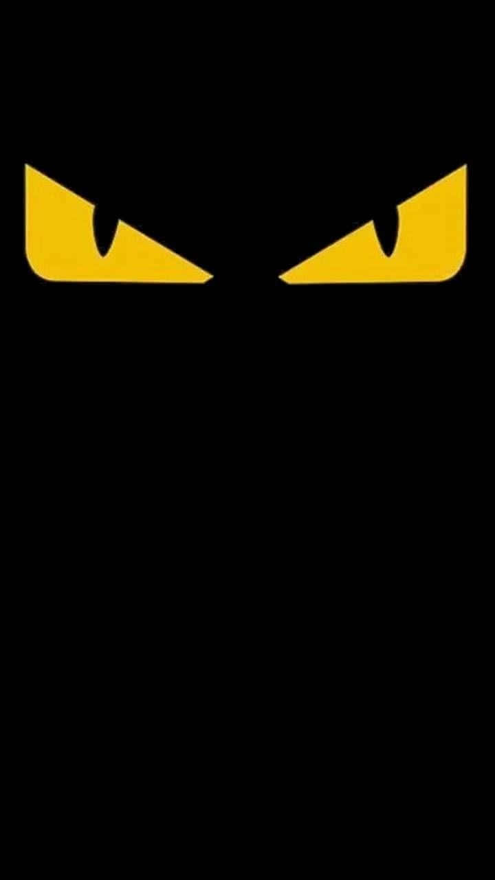 黑暗中威脅地凝視的兩隻發光黃色眼睛 — Valorant Logo 壁紙