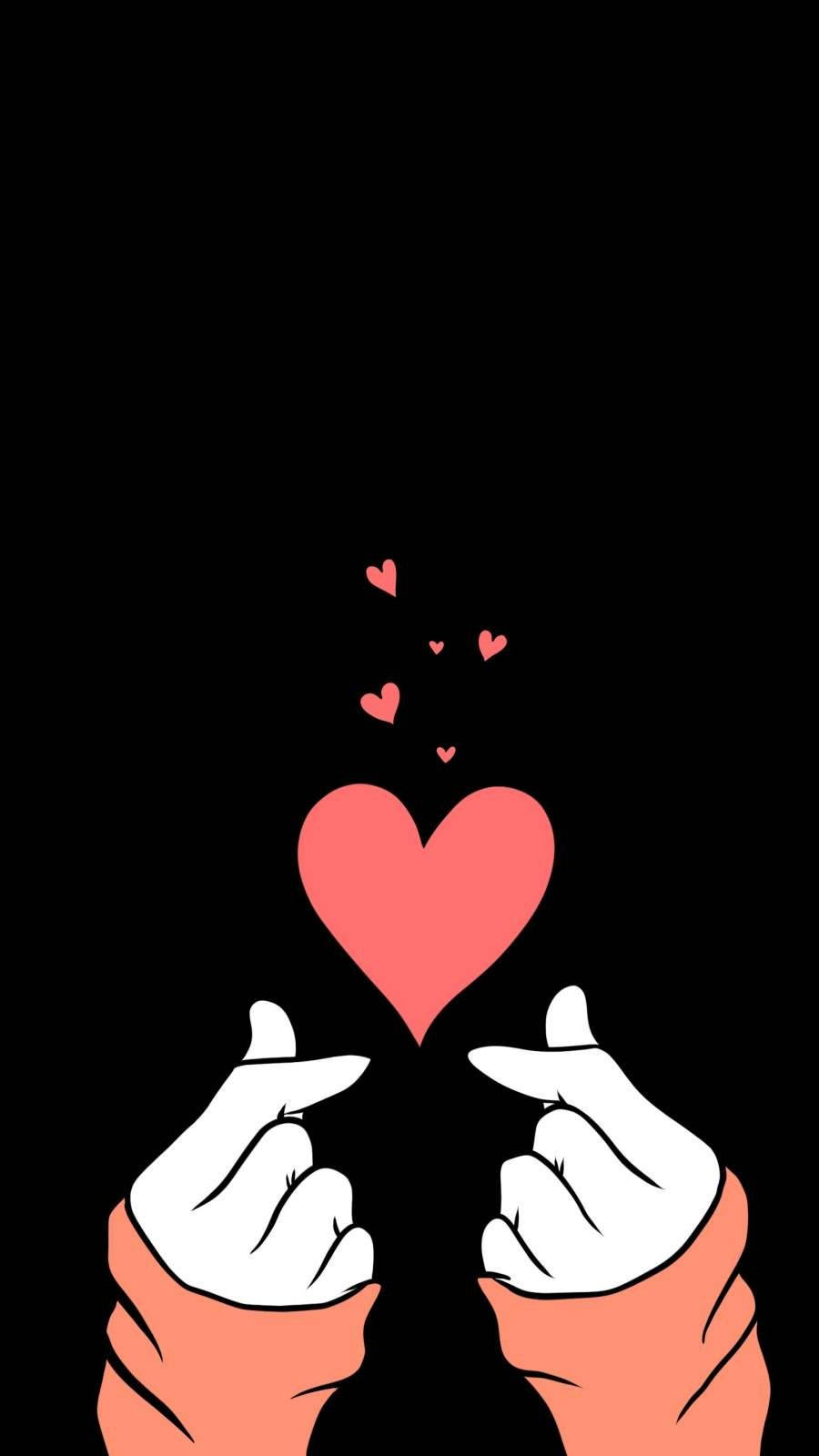 Love Phone 桌布 壁紙 — 兩隻穿著粉紅色袖子的手在黑色背景上輕輕形成一個心形，周圍有漂浮的粉紅色心形。