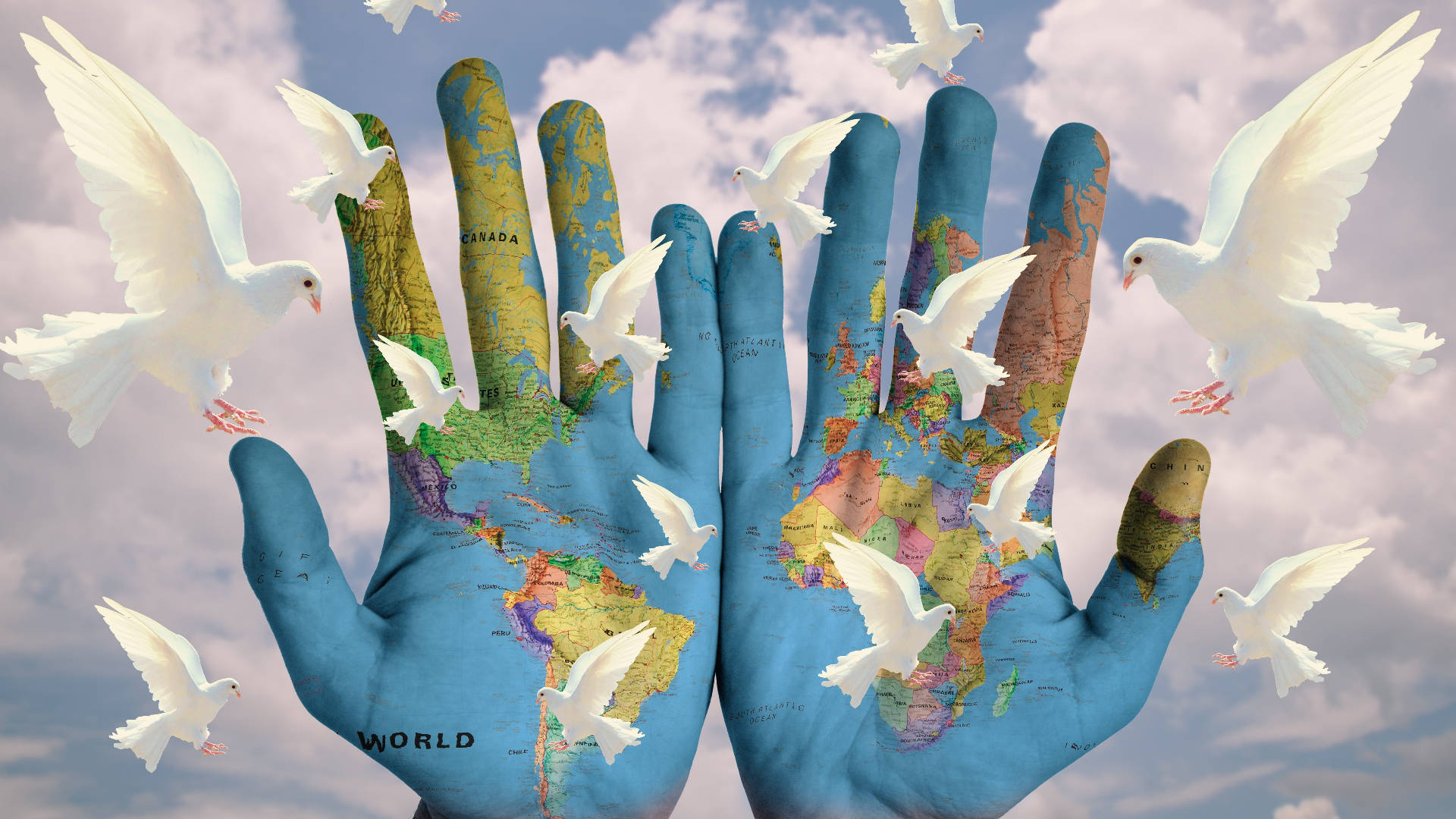 World 桌布 壁紙 — 兩隻繪有世界地圖的手托著在陰雲天空飛翔的白鴿。