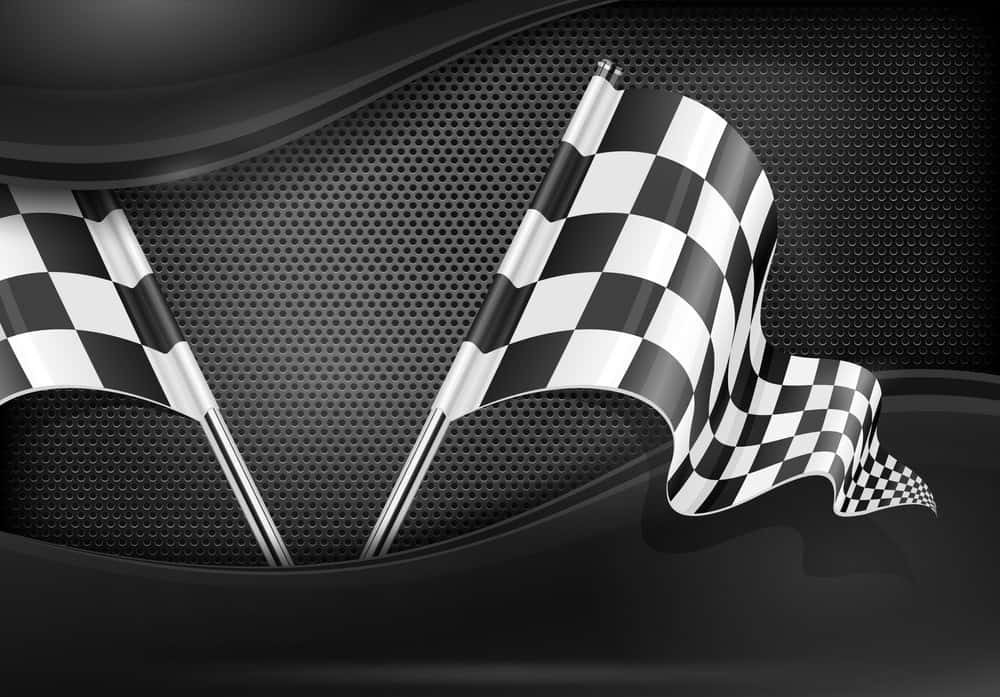 Chequered Flag 桌布 壁紙 — 兩面格紋賽車旗在光滑的黑色穿孔金屬背景上動態飄揚，帶有光澤曲線。