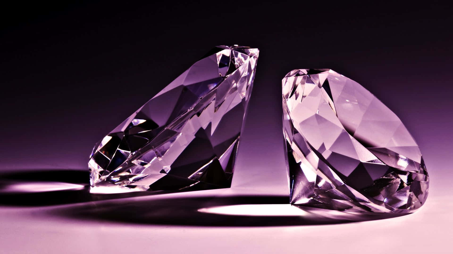 Diamond Aesthetic 桌布 壁紙 — 兩顆刻面紫鑽在柔和光線下閃耀，在漸變紫色表面上投下銳利陰影。