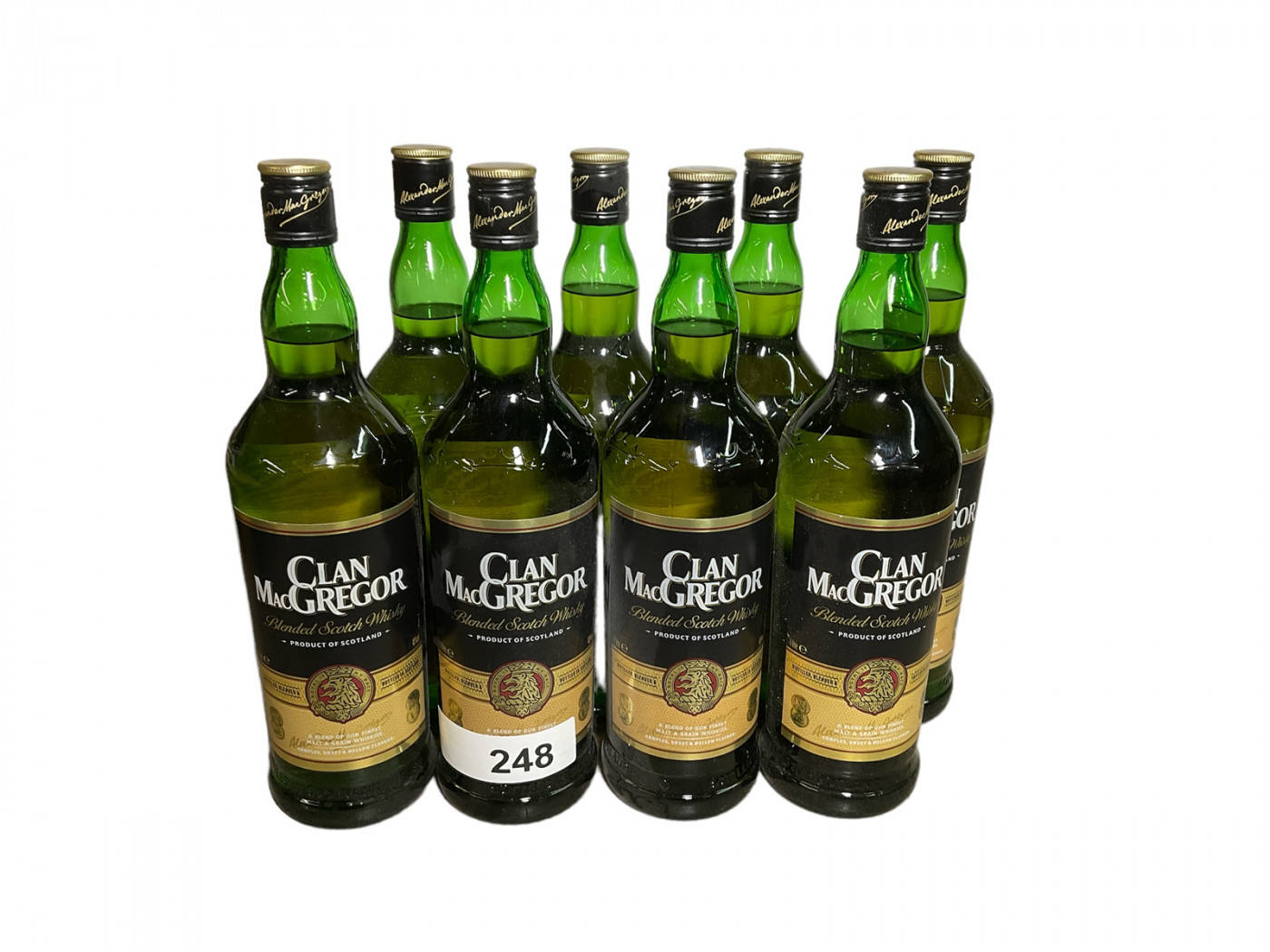 Whiskey 桌布 壁紙 — 六個綠色玻璃瓶的Clan MacGregor調和蘇格蘭威士忌，整齊排列在純白背景前。