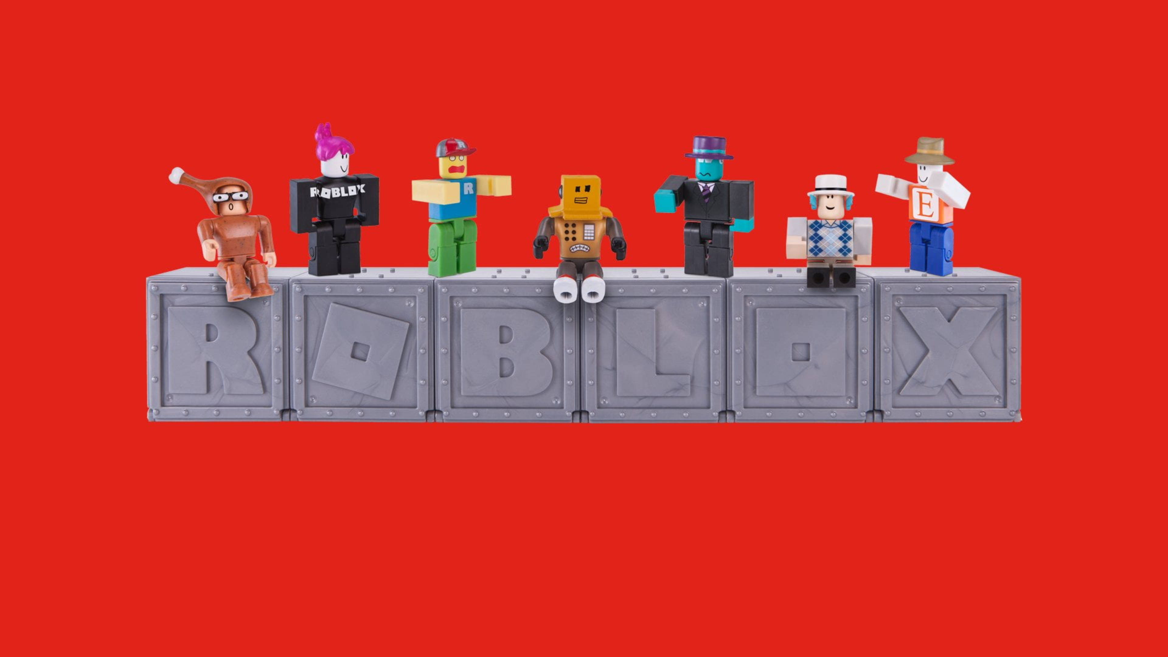 Roblox 桌布 壁紙 — 六個色彩繽紛的 Roblox 頭像站在灰色方塊上，拼出 ROBLOX，背景為大膽的紅色。