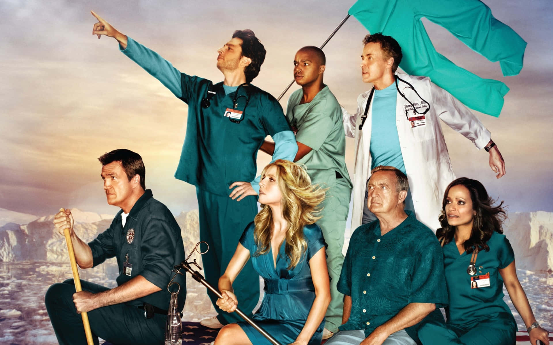 John C. Mcginley 桌布 壁紙 — 六名身穿青綠色手術服和白色外套的醫護人員，以戲劇性的山脈日落為背景，英勇地擺出姿勢。
