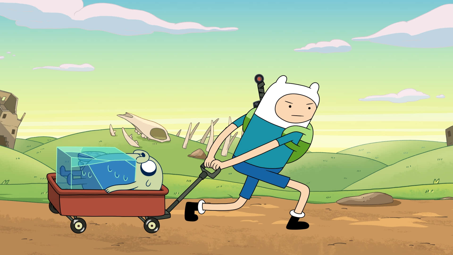 Adventure Time Cute 桌布 壁紙 — 冒險男孩拉著裝有藍色立方體生物的馬車，穿越起伏的綠色山丘，天空柔和。
