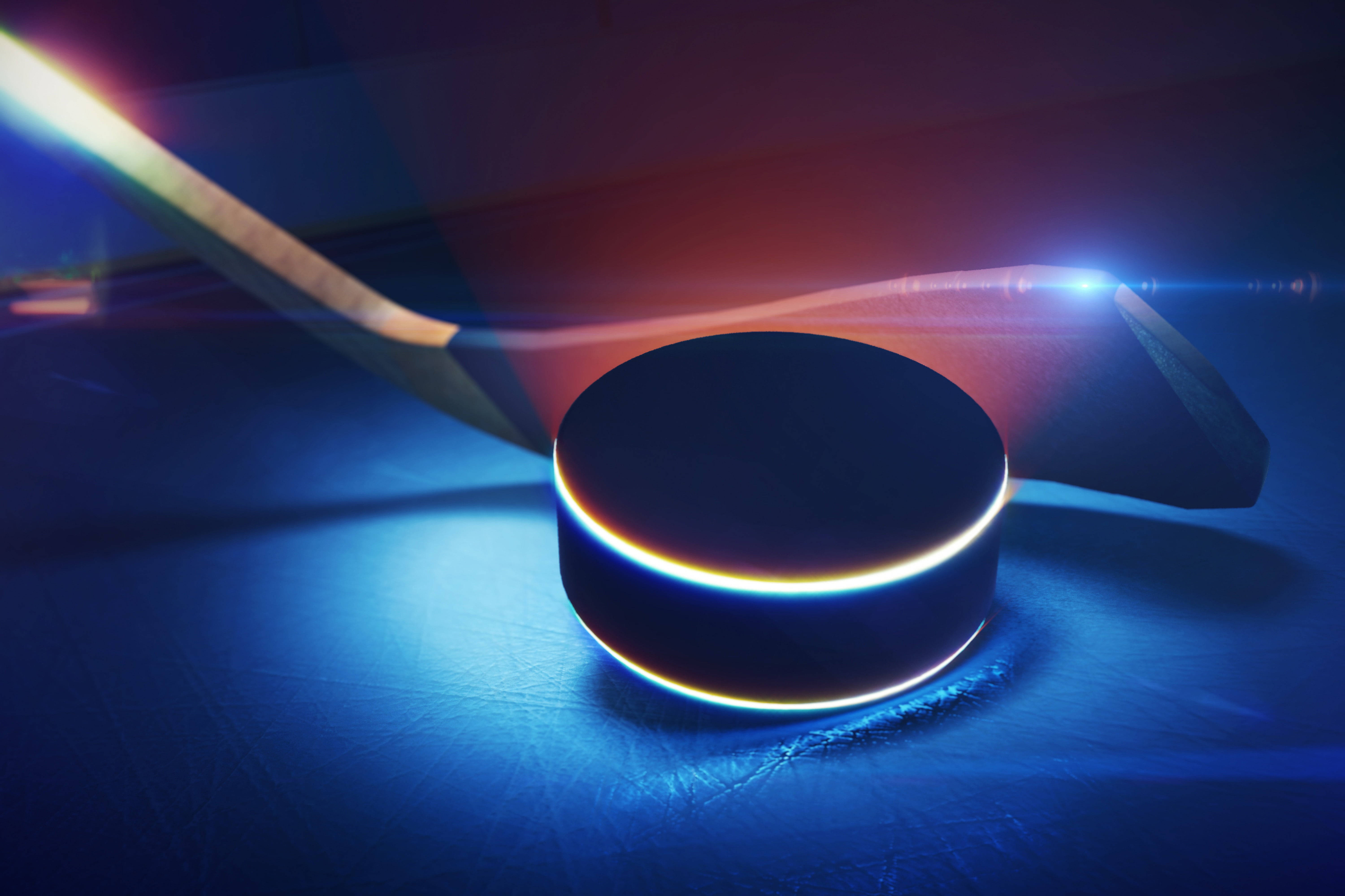 hockey 桌布 壁紙 — 冰球和球棍在冰面上，在戲劇性的鏡頭光暈下發出霓虹藍和紅光。