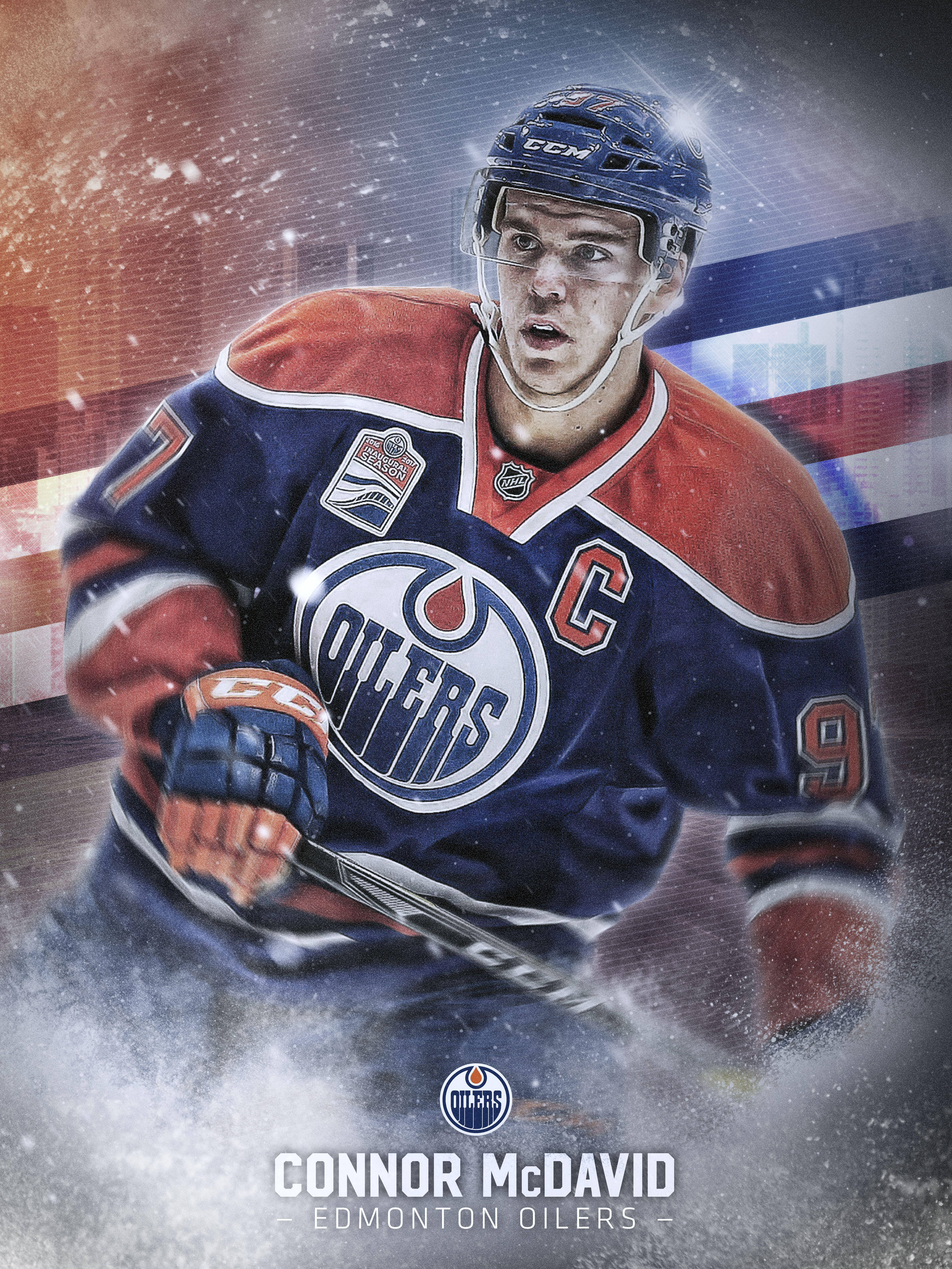hockey 桌布 壁紙 — 冰球球員 Connor McDavid 身穿 Edmonton Oilers 裝備，在雪景城市背景下充滿力量地向前衝刺。