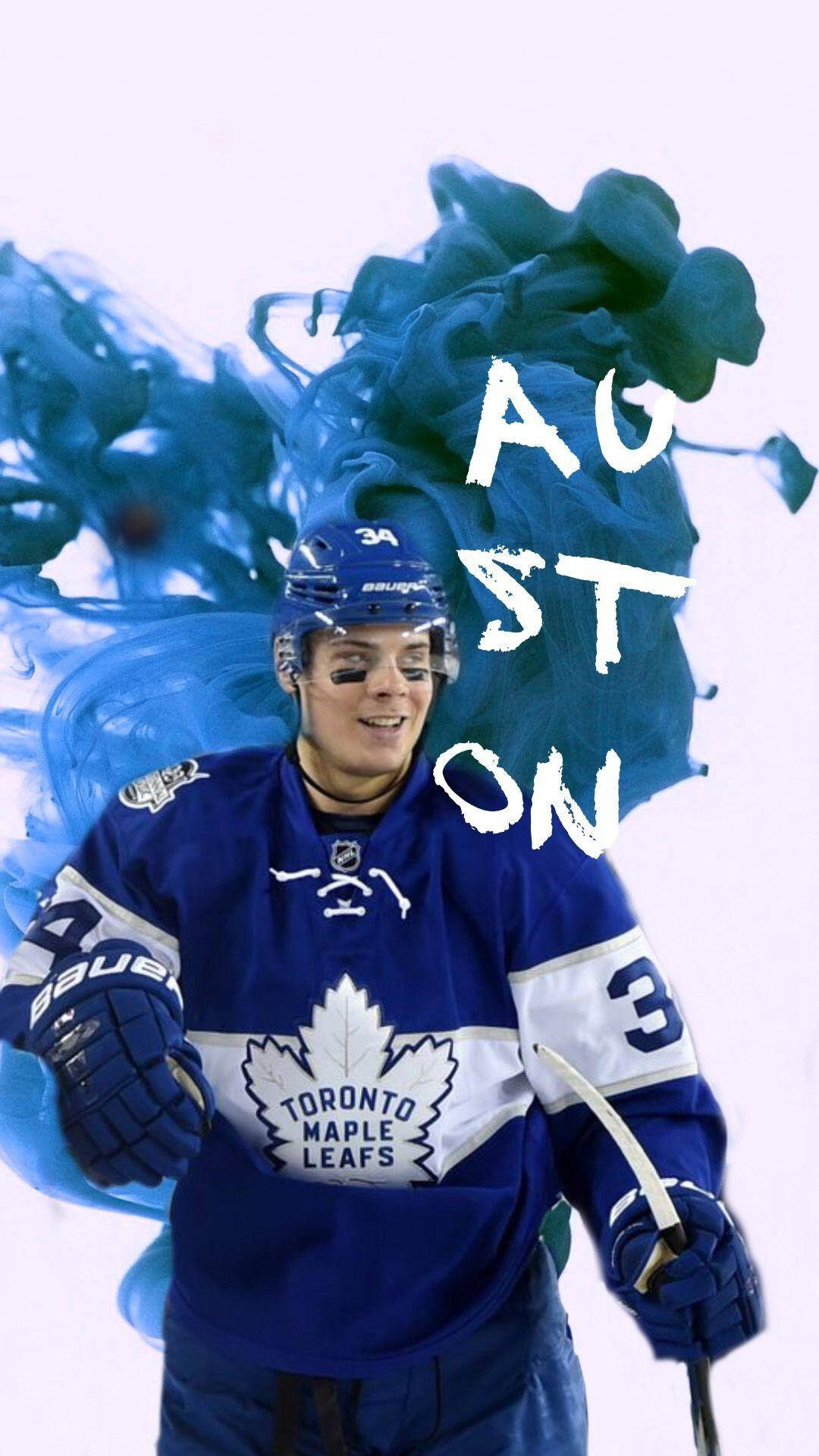 藍色 桌布 壁紙 — 冰球運動員 Auston Matthews 身穿多倫多楓葉隊裝備微笑，身後藍色墨水旋轉，他的名字以粗體白色字母呈現。
