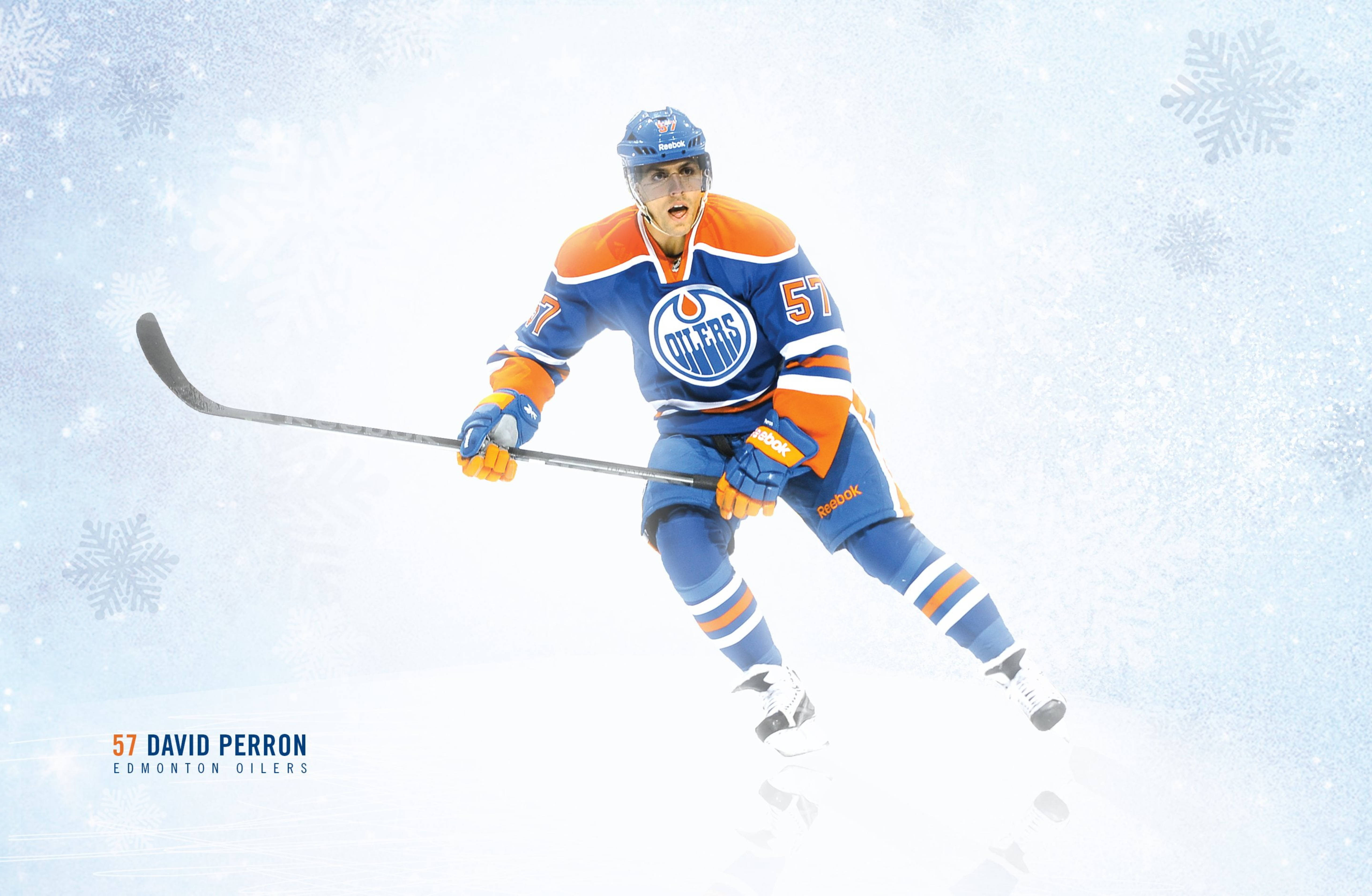 Oilers 桌布 壁紙 — 冰球運動員大衛·佩倫身穿愛德蒙頓油人隊裝備，在雪花紛飛的雪地場館中動態滑行。