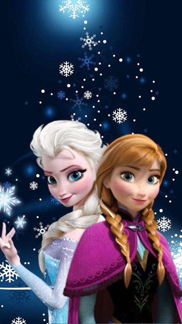 anna 桌布 壁紙 — 《冰雪奇緣》中的艾莎和安娜站在一起，背景是深藍色的天空，充滿發光的雪花和閃爍的光芒。