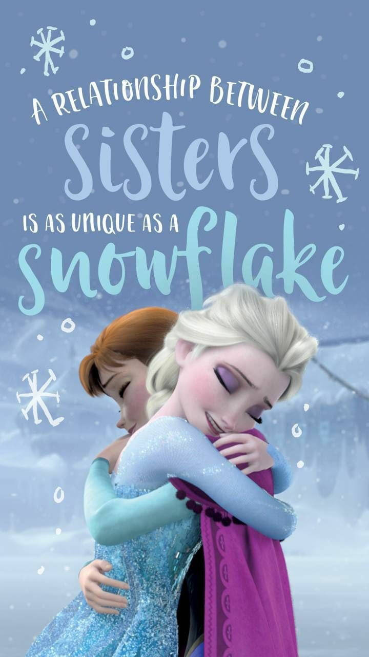 anna 桌布 壁紙 — 《冰雪奇緣》的安娜和艾莎在雪景背景下溫暖擁抱，飄浮的雪花和勵志文字點綴其中。