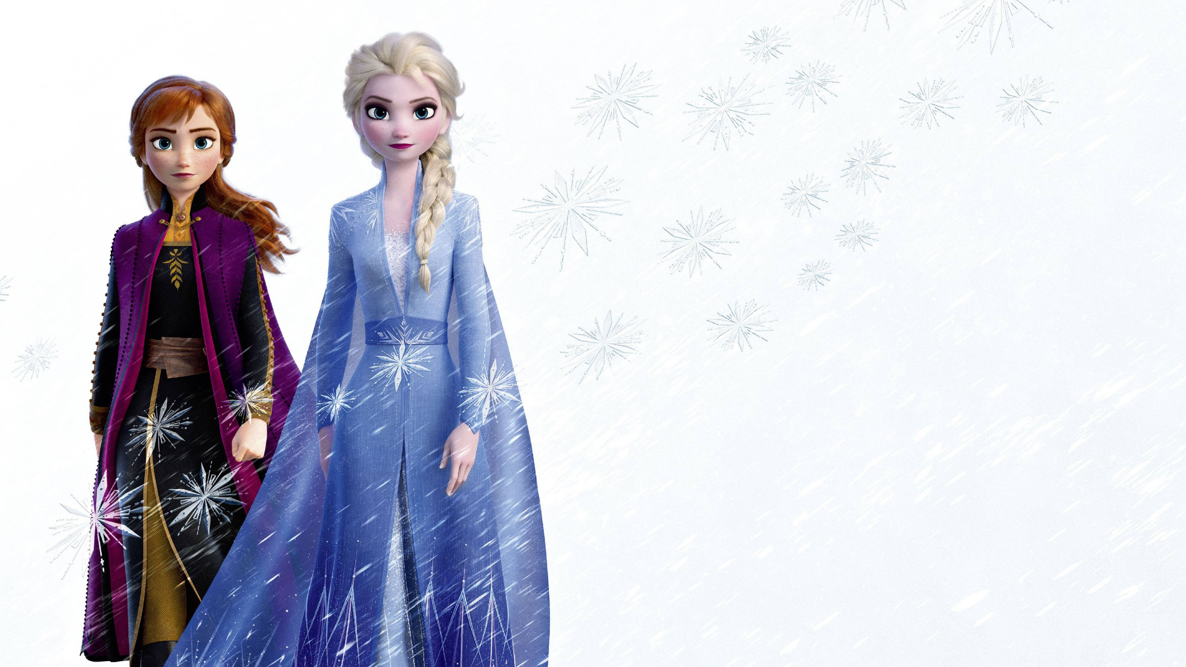 Frozen Elsa 桌布 壁紙 — 《冰雪奇緣》的安娜和艾莎身穿冰冷冬日服飾，在雪花飄落的雪景背景下並肩站立。