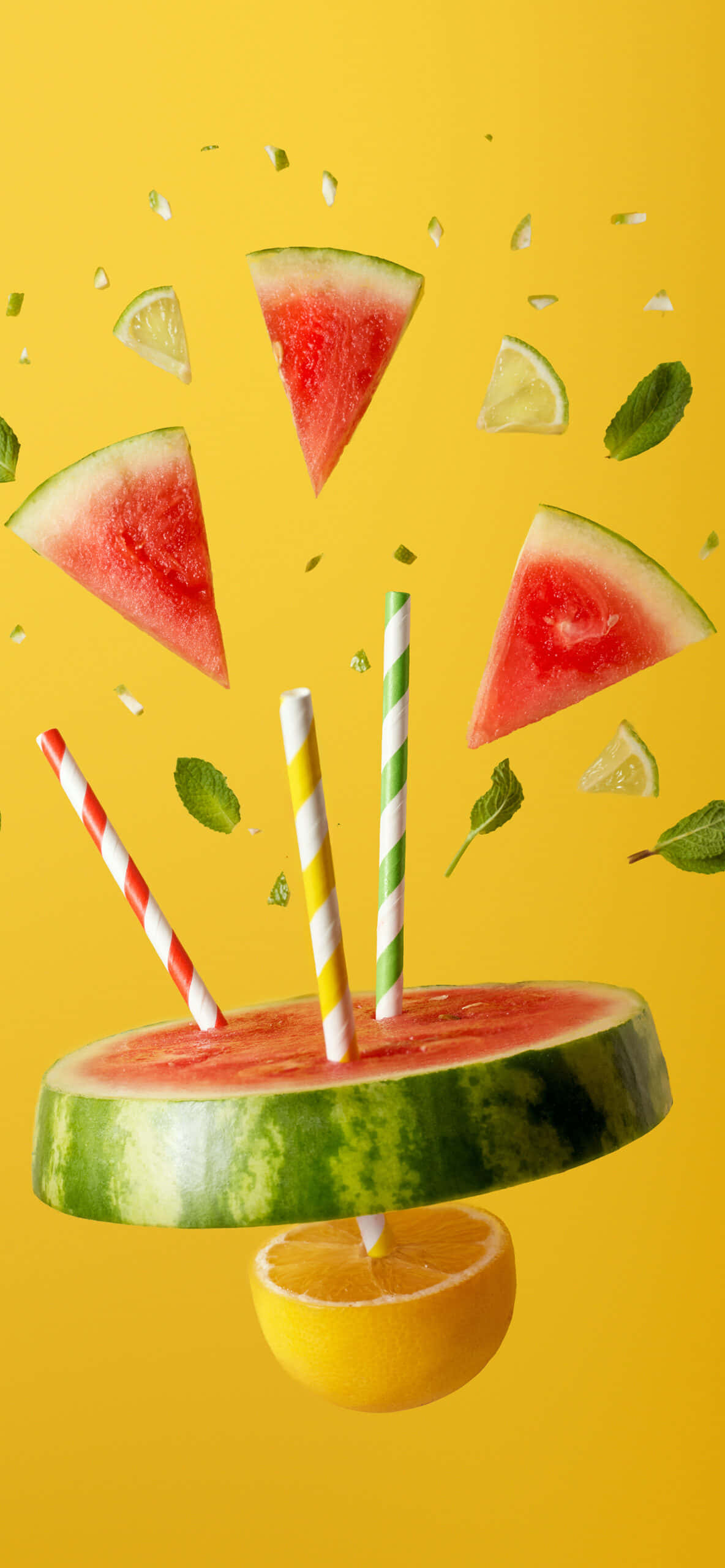 Watermelon iPhone 桌布 壁紙 — 切片西瓜配條紋吸管和柑橘片懸浮在半空中，背景為鮮黃色。