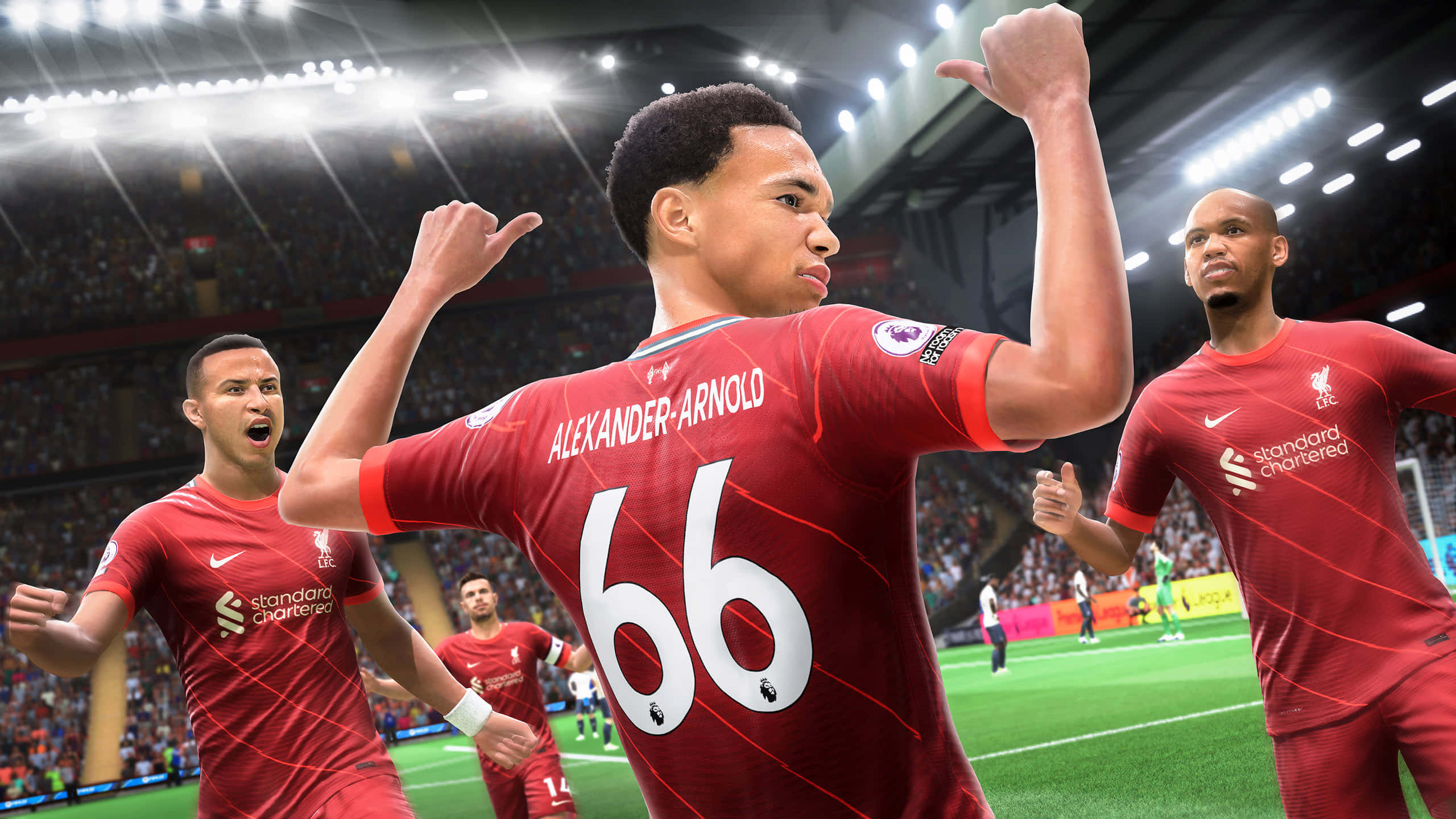Fifa 22 桌布 壁紙 — 利物浦足球員身穿紅色球衣，在明亮的球場燈光下慶祝進球，背景有歡呼的球迷。