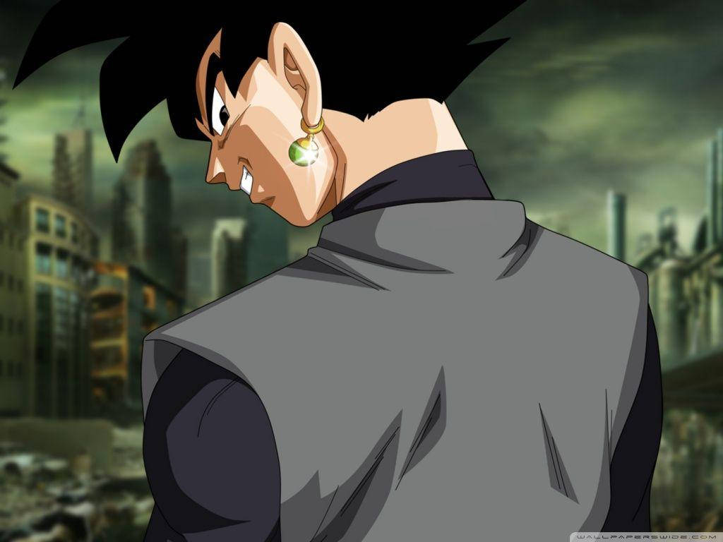 Black Goku 桌布 壁紙 — 動漫角色，黑色刺蝟頭，綠色耳環，在陰沉的城市天際線背景下，猛地回頭。