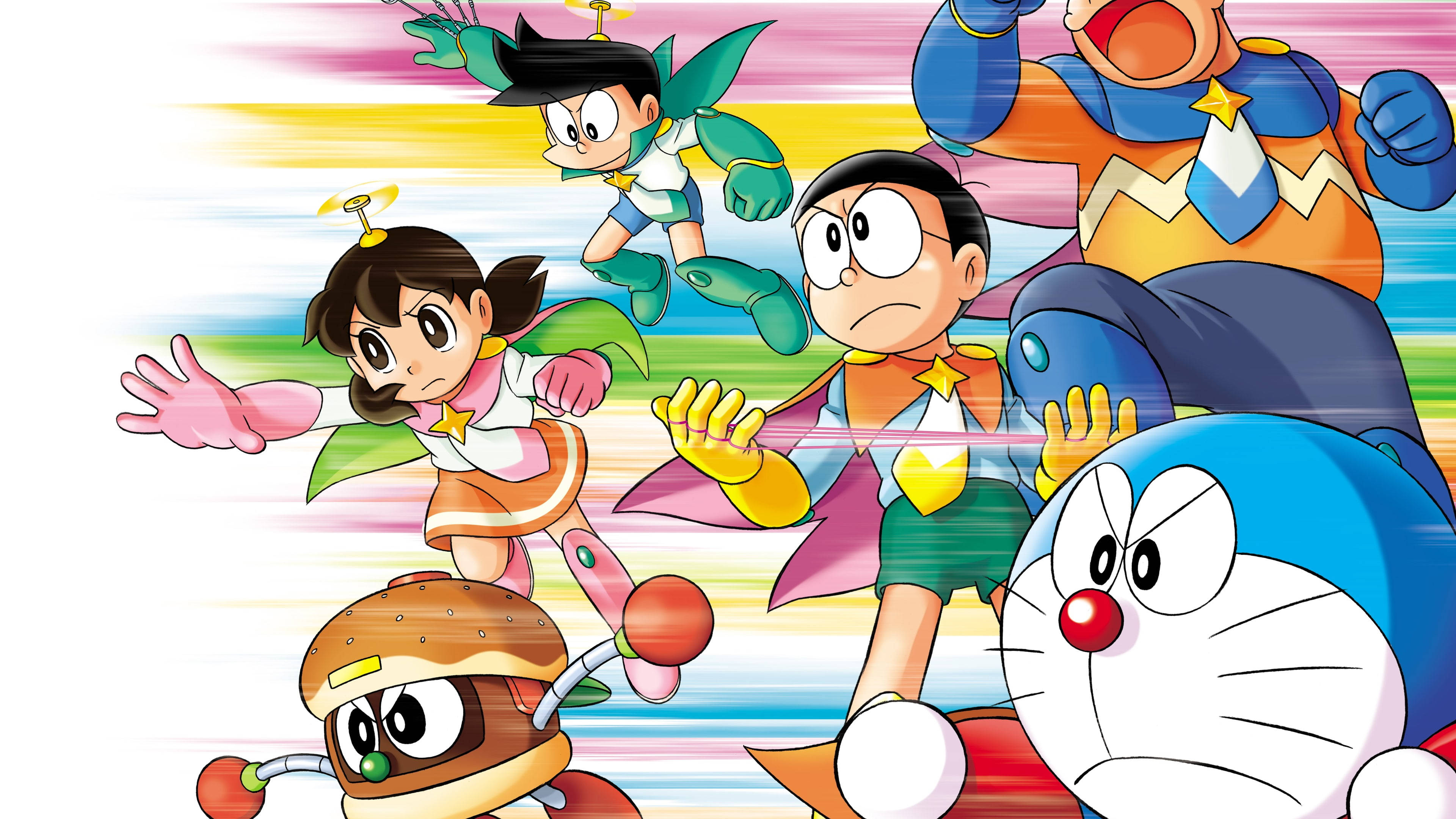 Doraemon 桌布 壁紙 — 動漫角色以超級英雄姿勢在彩虹條紋背景前展現動感。